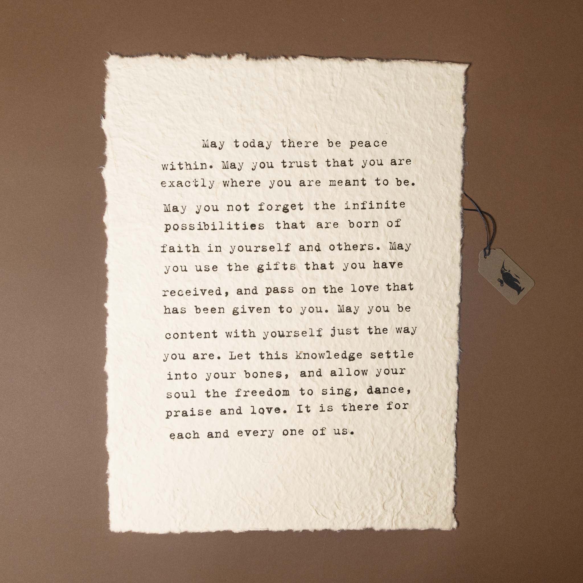 Text on a textured paper with a tag on a brown background