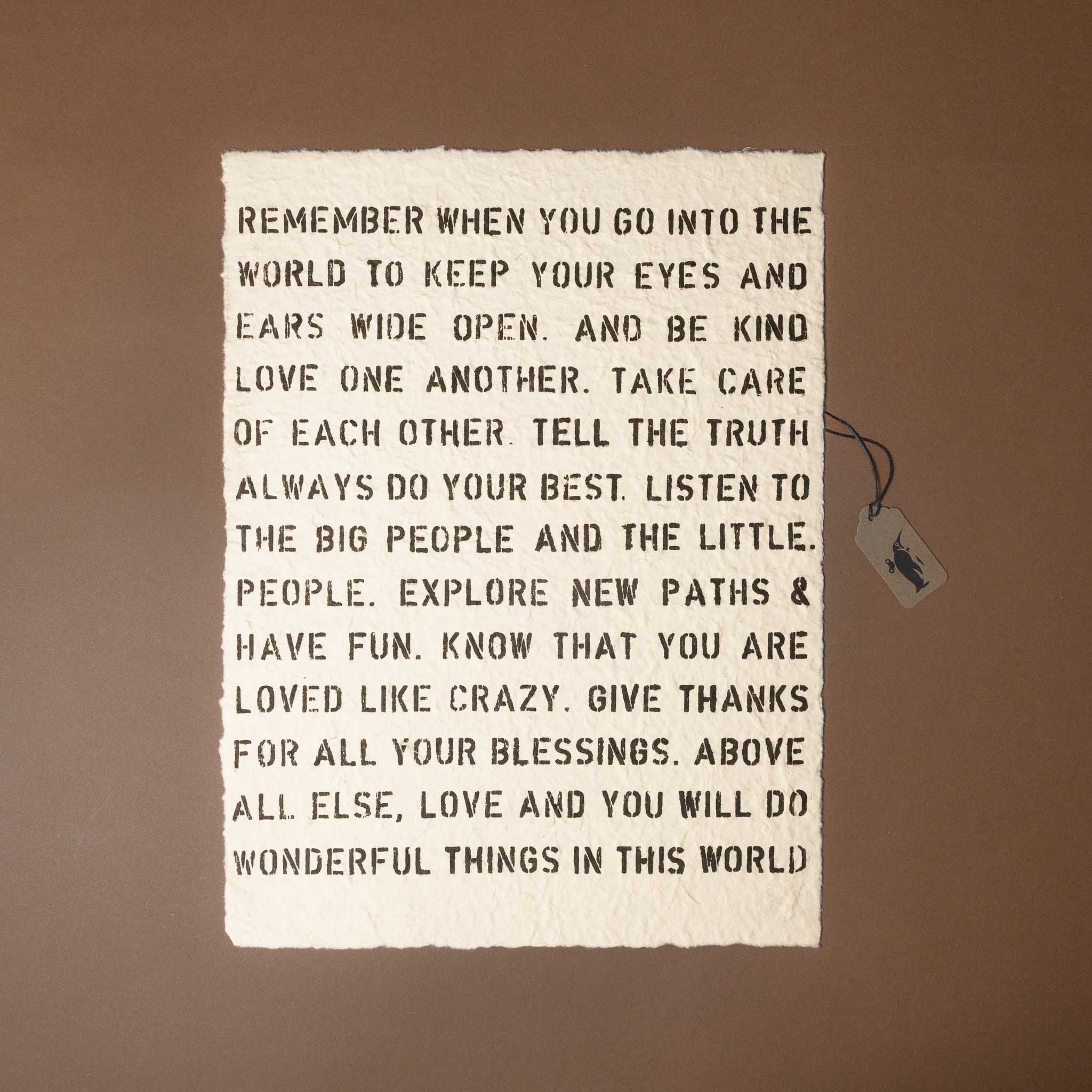 Motivational quote on a textured paper with a tag against a brown background