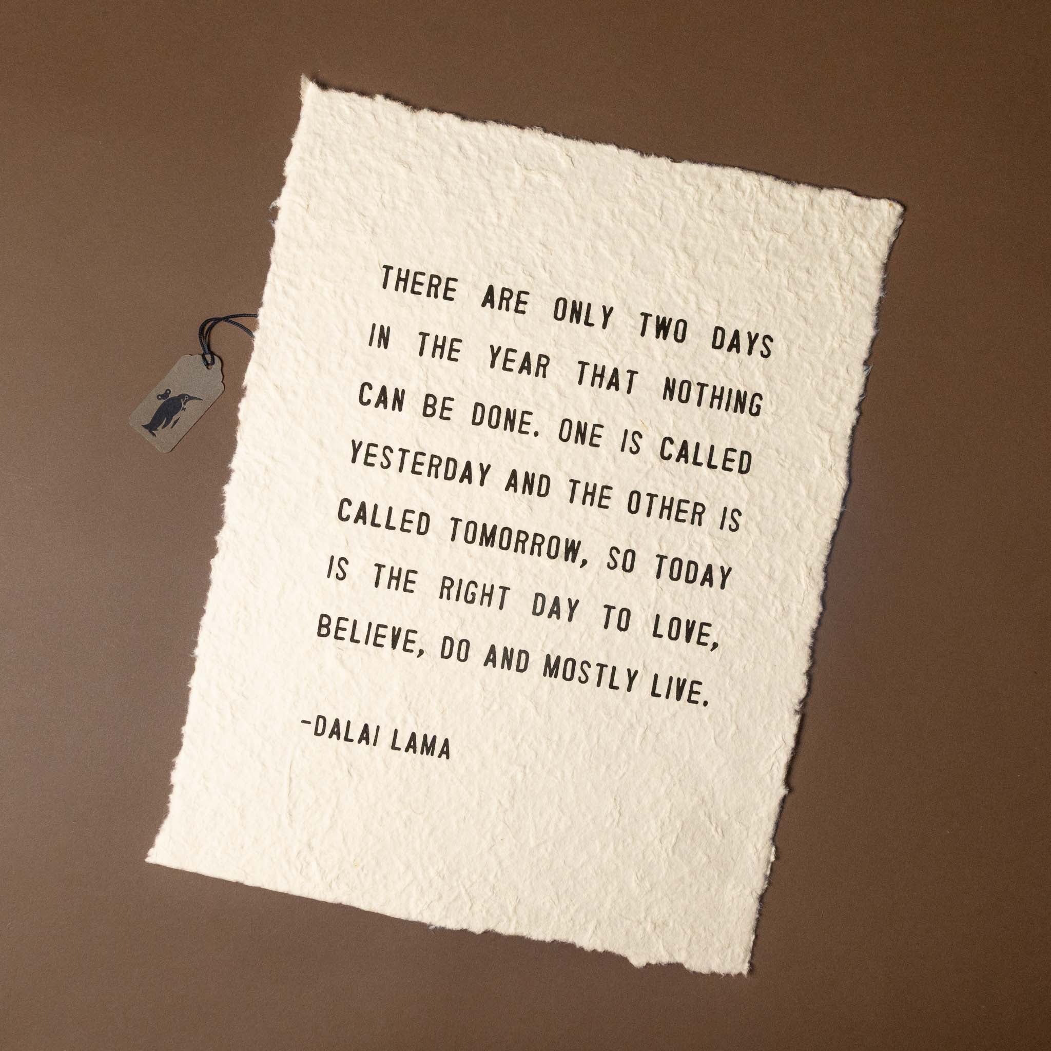 Textile with a Dalai Lama quote on a brown background