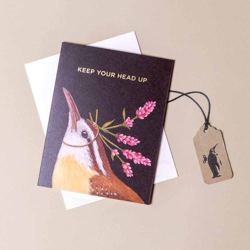 Greeting card with a bird illustration and 'Keep Your Head Up' text, accompanied by a tag on a beige background.