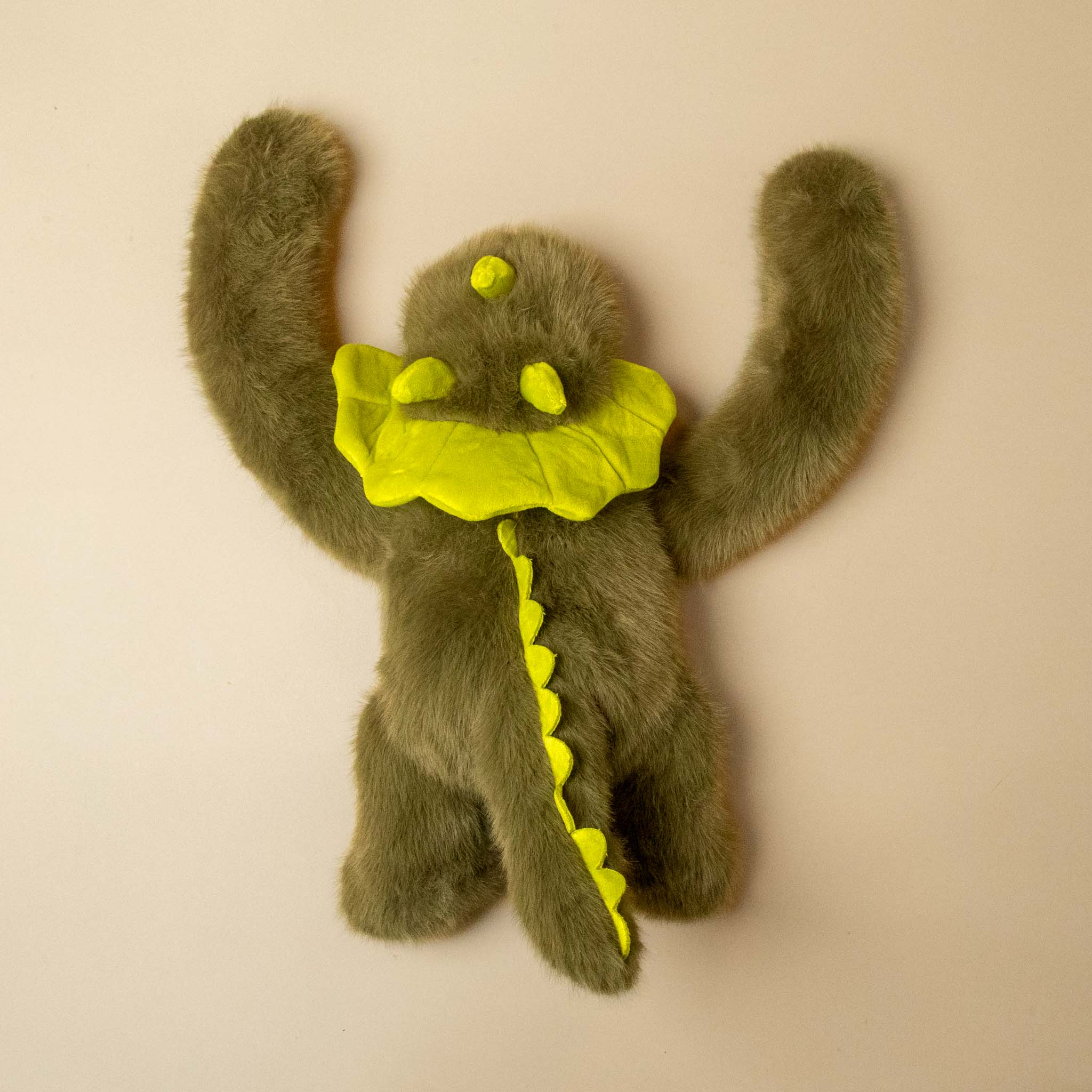 green weighted-dino stuffed animial