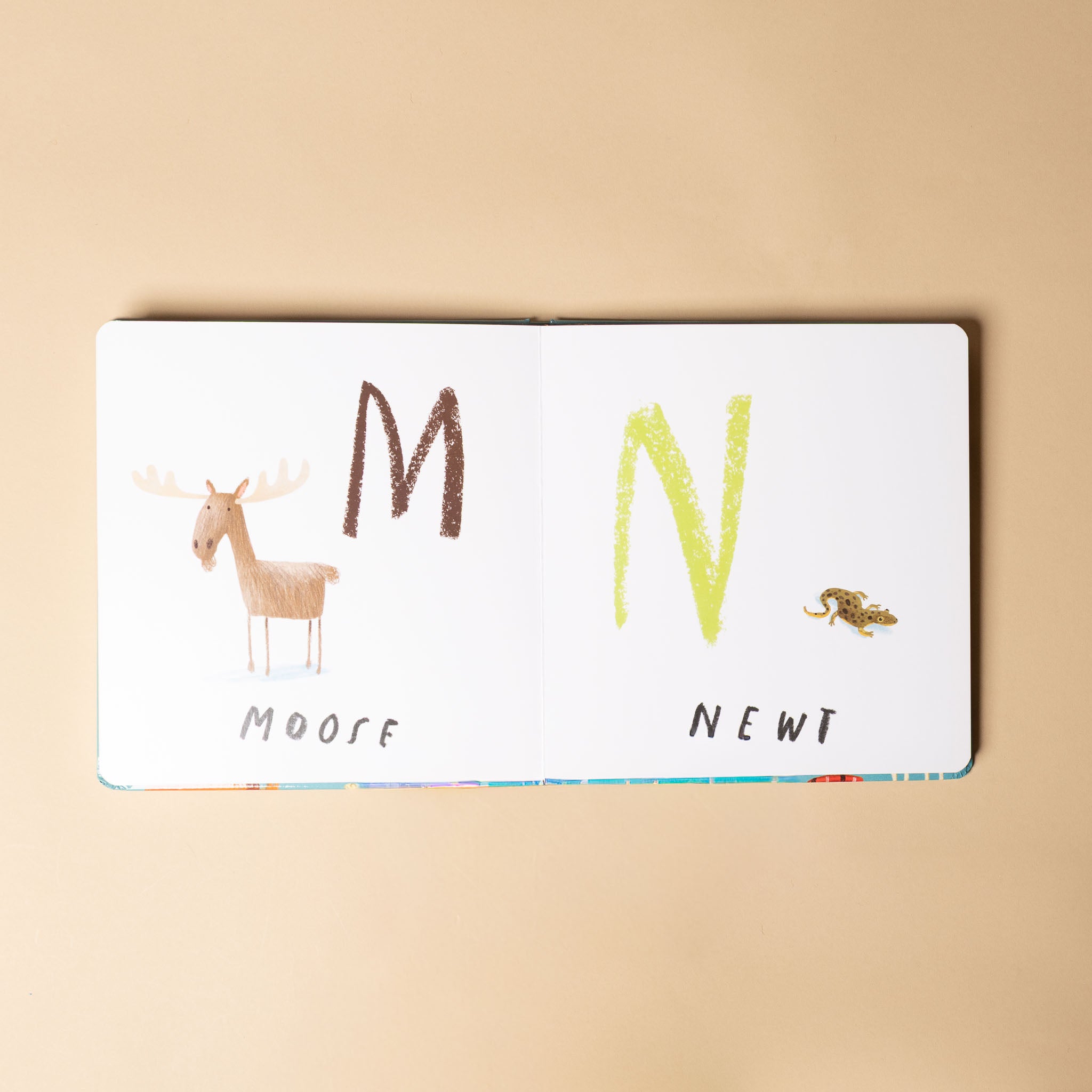 here-we-are--board-book-of-animals with letters 'M' and 'N', moose illustration, and text on a beige background