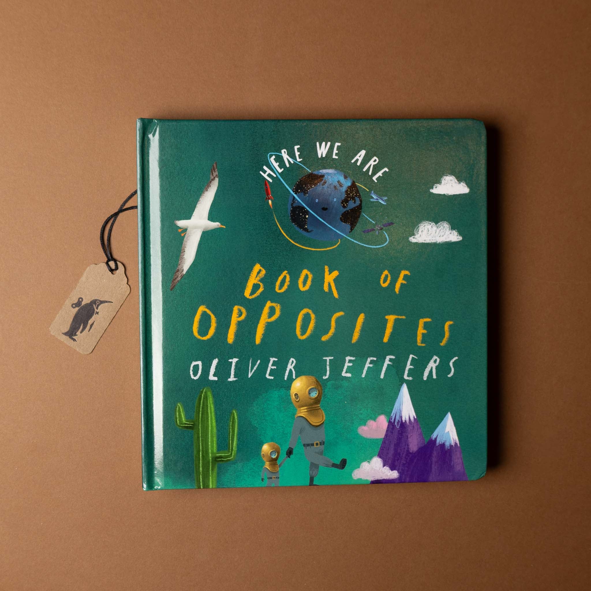 Book titled 'Book of Opposites' by Oliver Jeffers on a brown background