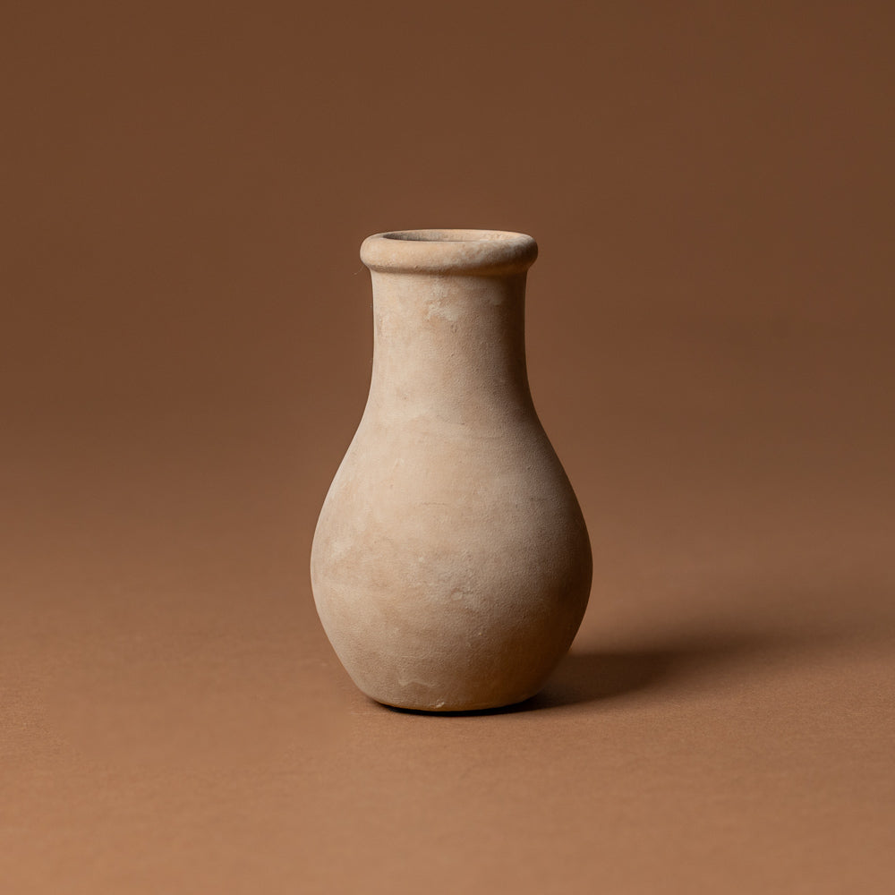 holden-bud-vase-small Beige ceramic vase on a brown background