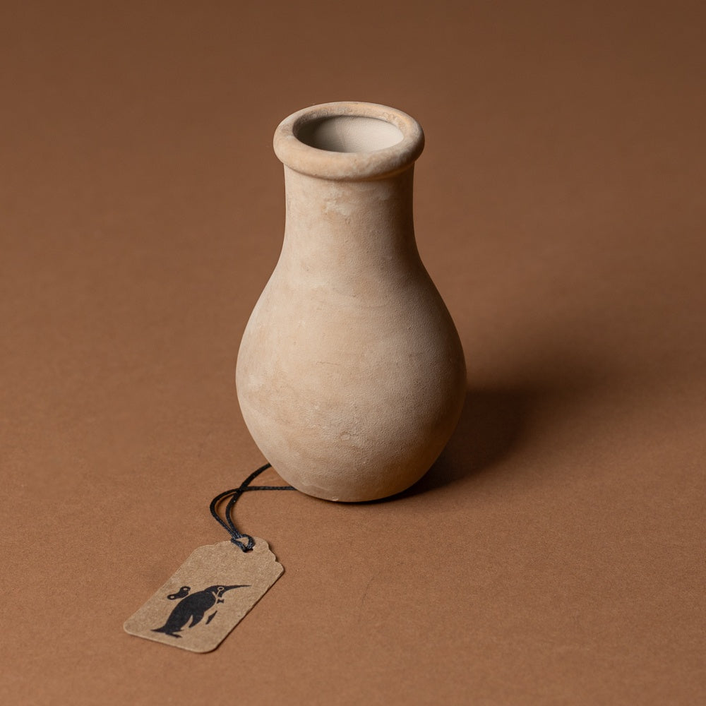 holden-bud-vase-small Beige ceramic vase with a tag on a brown background