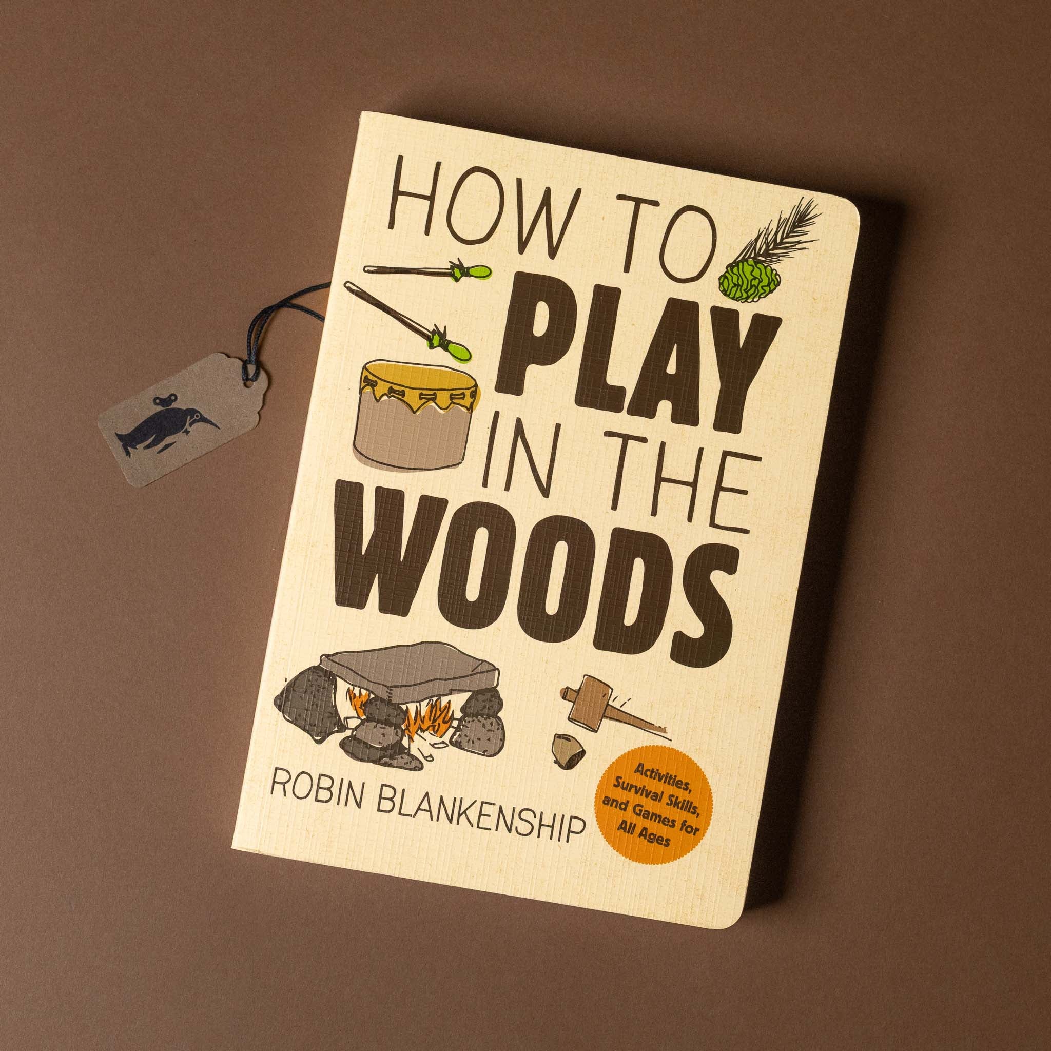 Book titled 'How to Play in the Woods' by Robin Blankenship on a brown background