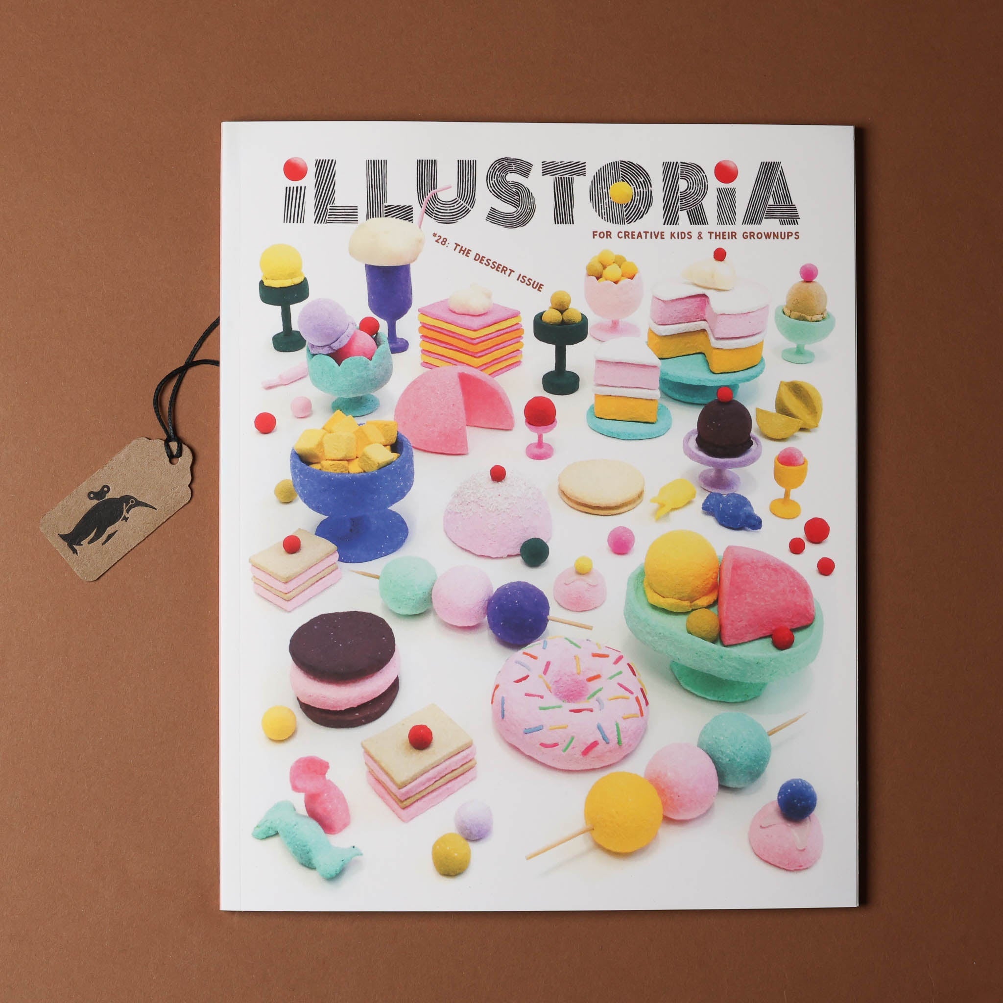 Magazine cover titled 'Illustroria' with colorful illustrations of desserts on a brown background