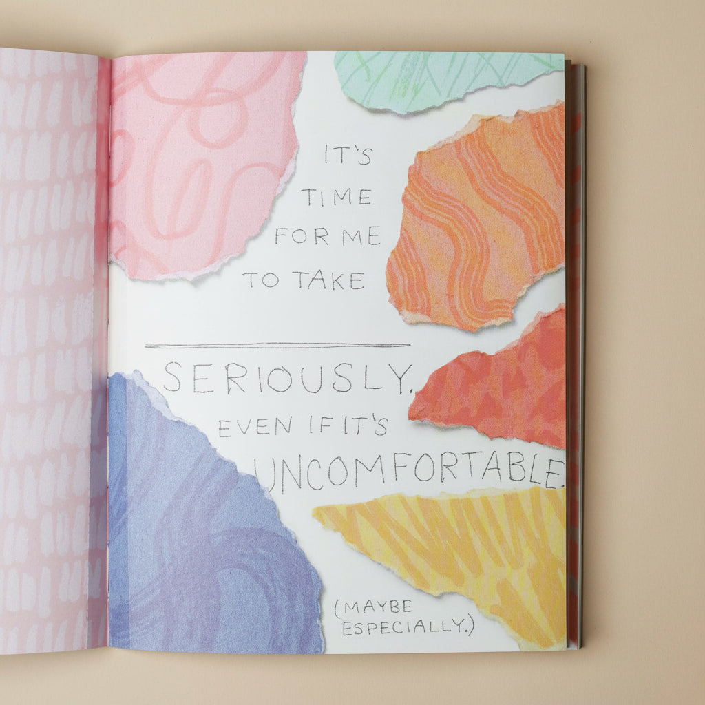 Open im-not-doing-that-any-more-book with colorful abstract design and motivational quote on a beige background