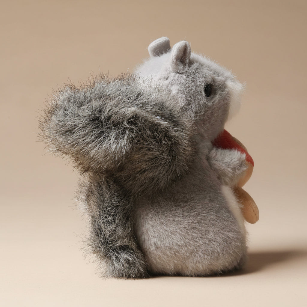 Plush toy little-grey-squirrel-with-toadstool on a beige background