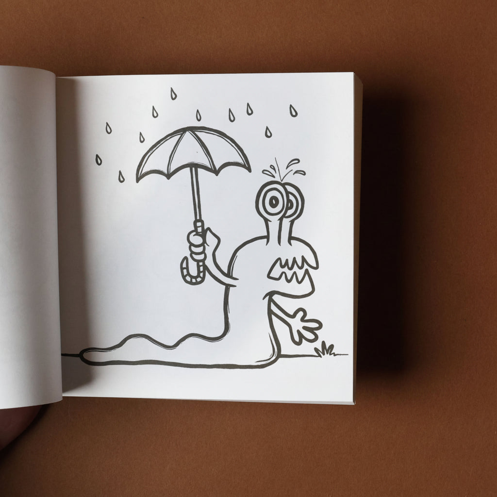 Illustration of a creature holding an umbrella in the rain on a open book against a brown background