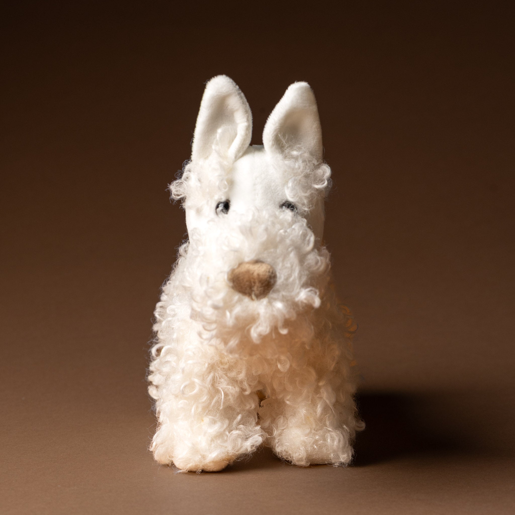 lola-the-dog White stuffed dog toy on a brown background