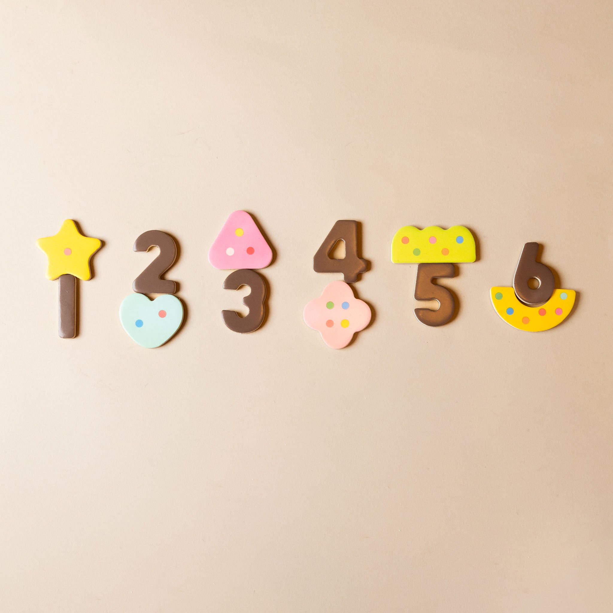 Colorful number magnets on a beige background