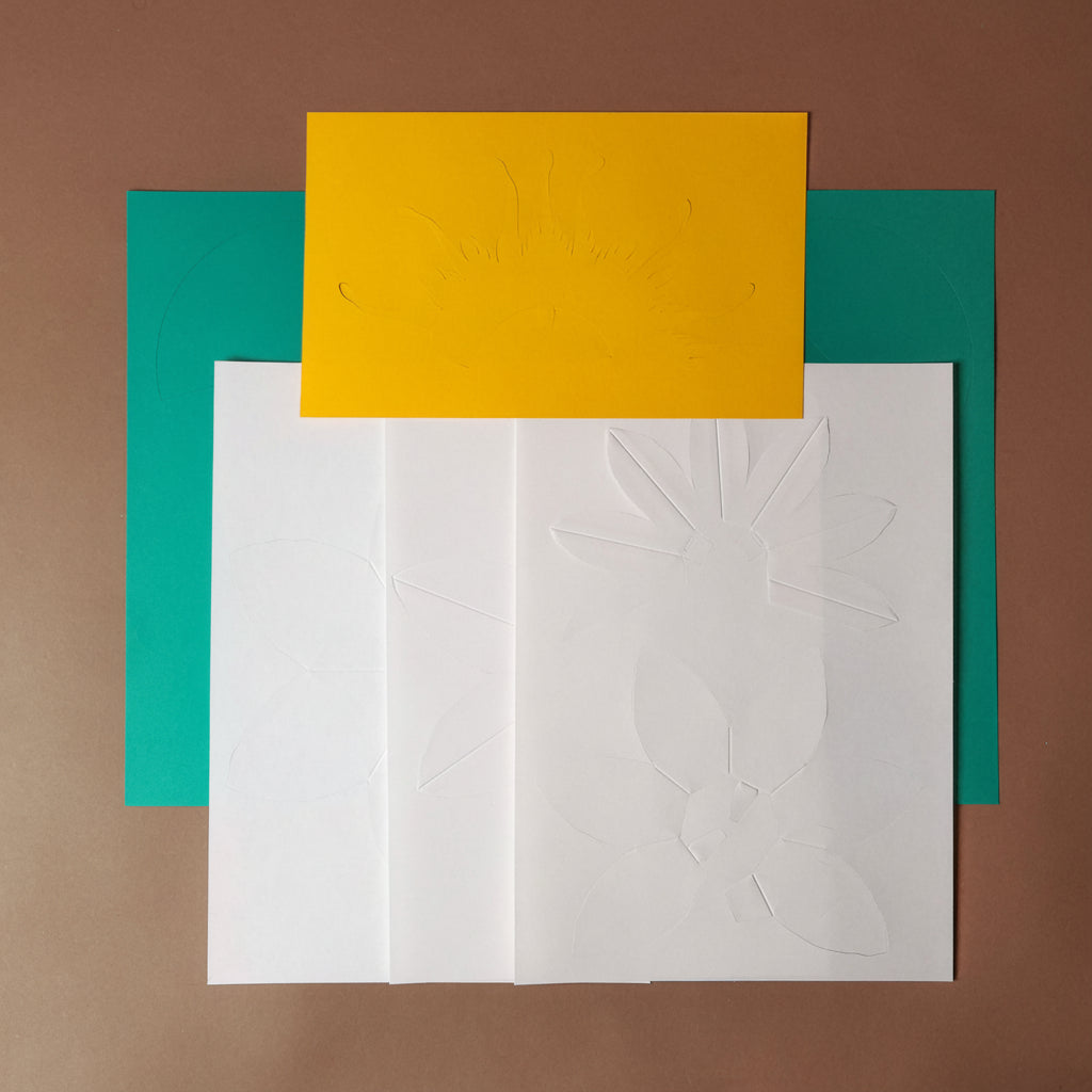 make-your-own-3d-waterlily-paper-mode Four colorful square cards on a brown background