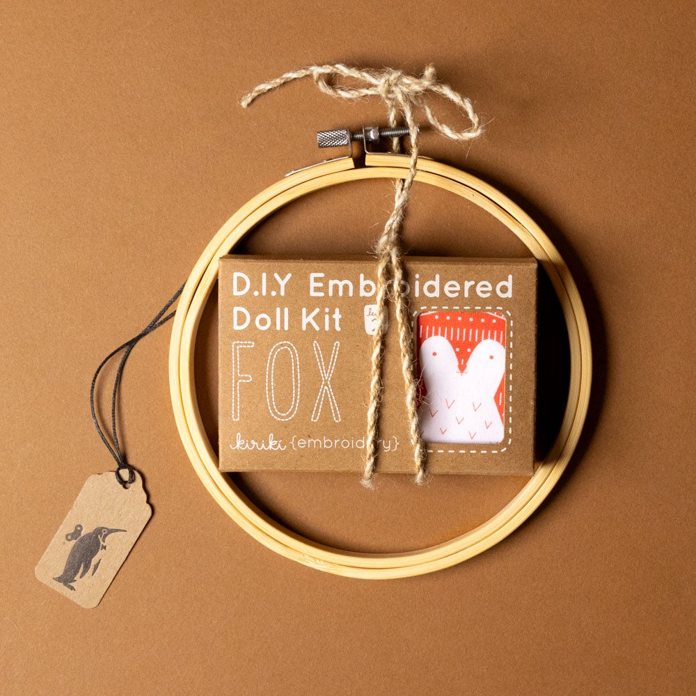 make-your-own-embroidered-animal-kit--fox with hoop and packaging on a brown background