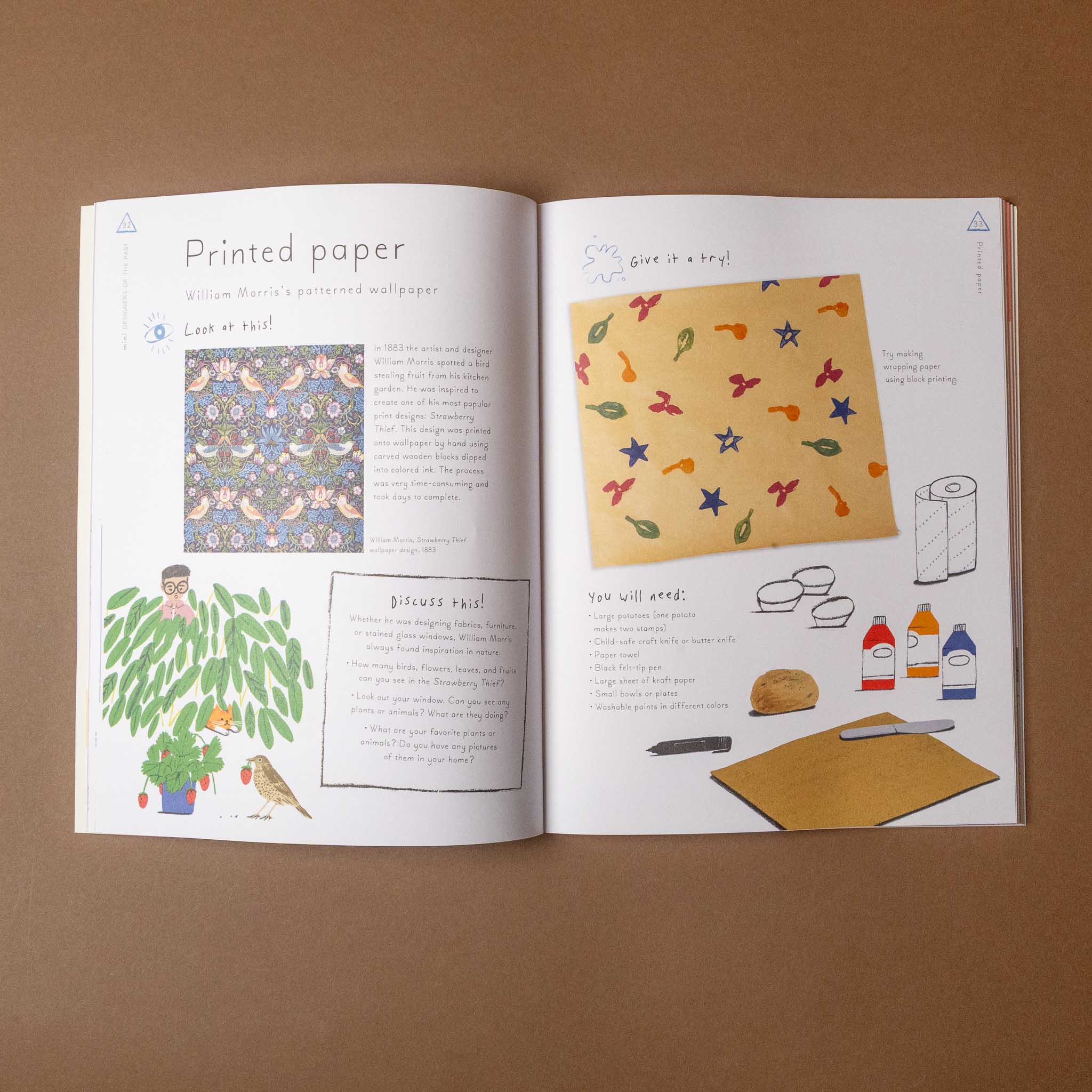 Open mini-designers-activity-book showing printed paper with patterns and illustrations on a brown background