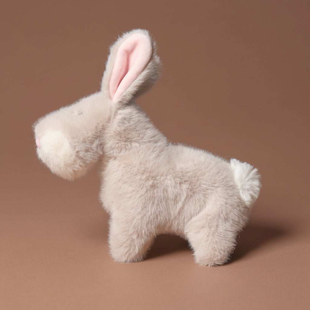 muzzle-bernadette-bunny-small Plush toy rabbit on a brown background