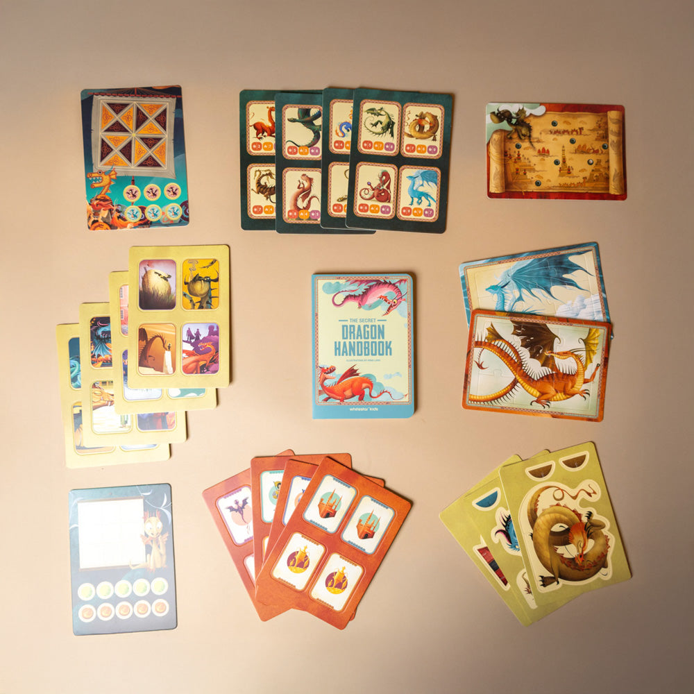 my-little-interactive-box-of-dragons Collection of dragon-themed cards on a beige background