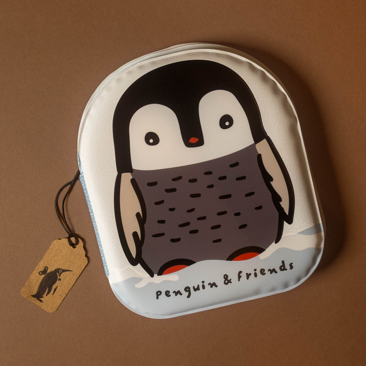 A small penguin--friends-bath-book featuring a cartoon penguin design with the text 'Penguin & friends' on a brown background, with a small paper tag attached.