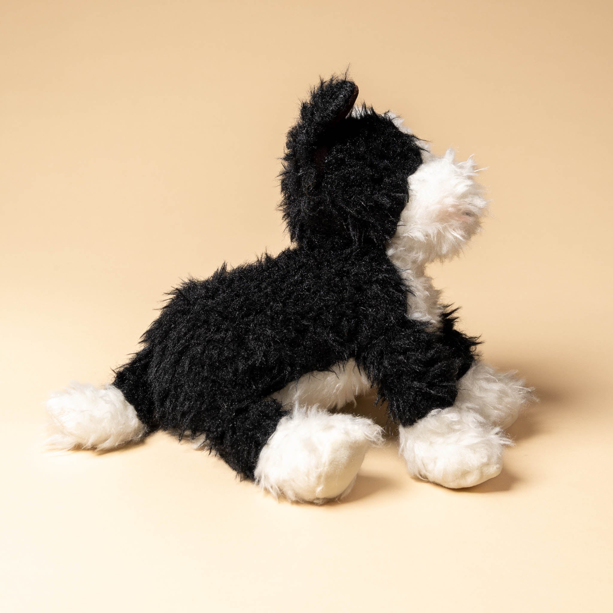 pepper-the-farm-dog Black and white plush toy on a beige background