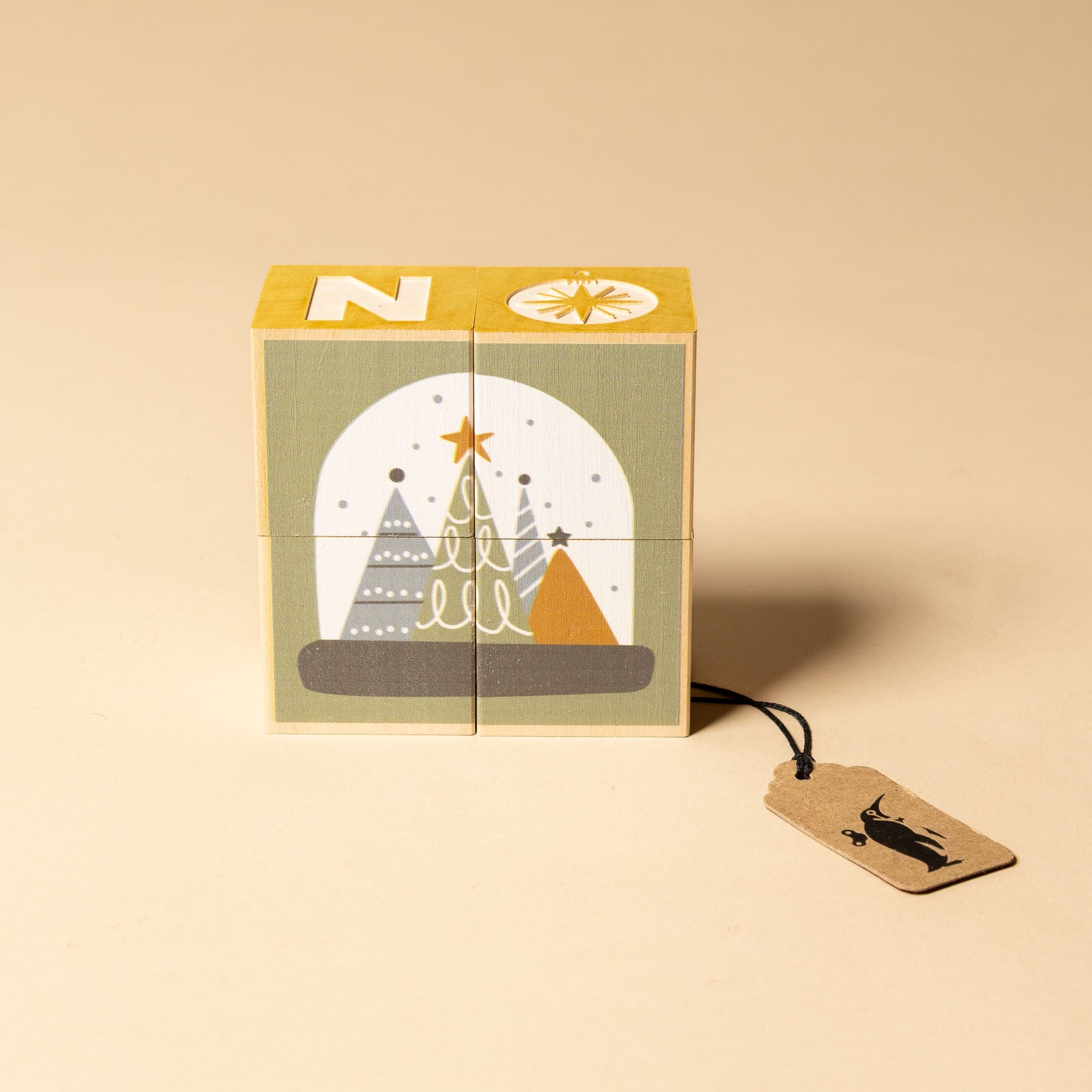 petite-wooden-gifting-block-set-snowglobe Wooden block with Christmas snowglobe tree design and a tag on a beige background