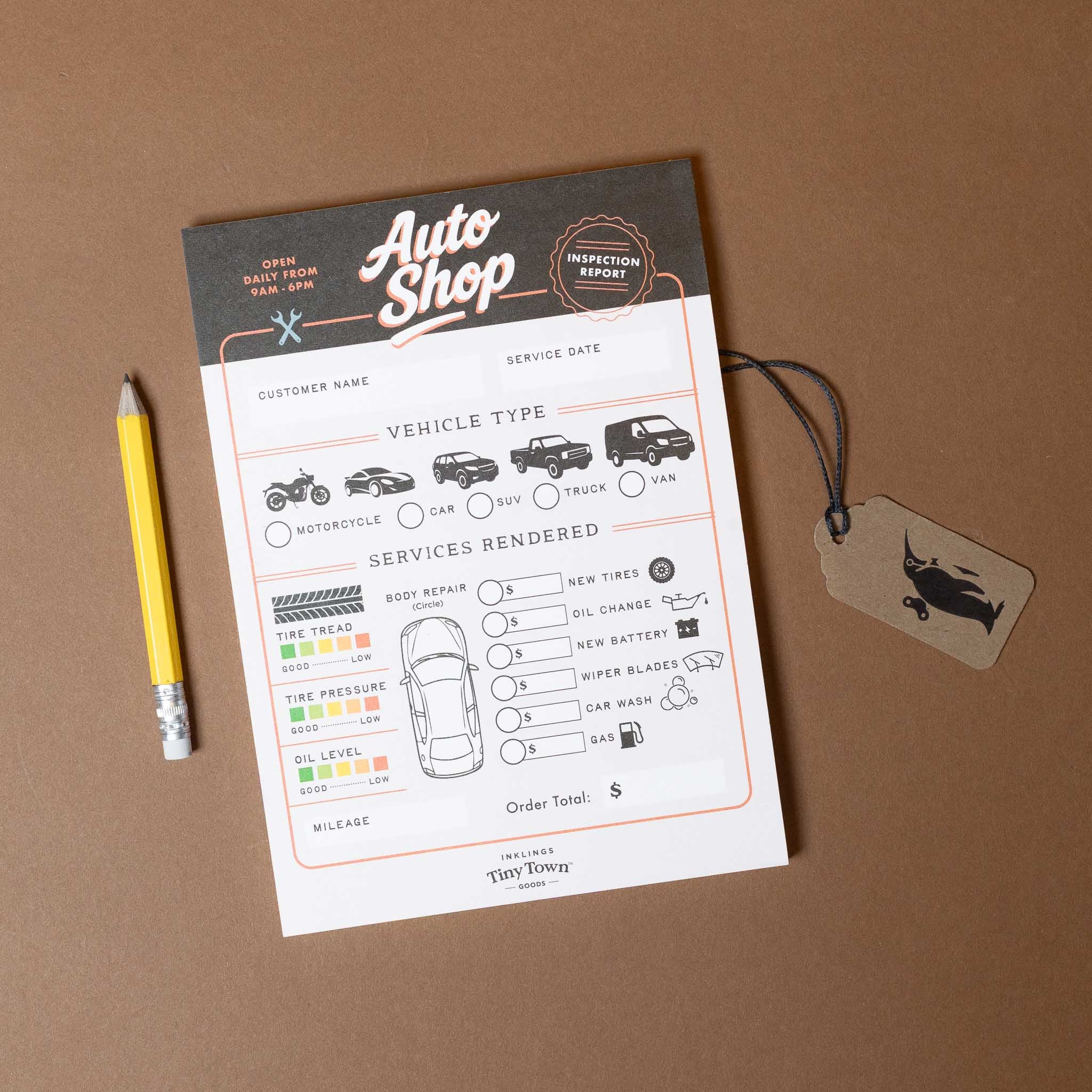 Auto shop inspection report form with a pencil and tag on a brown background