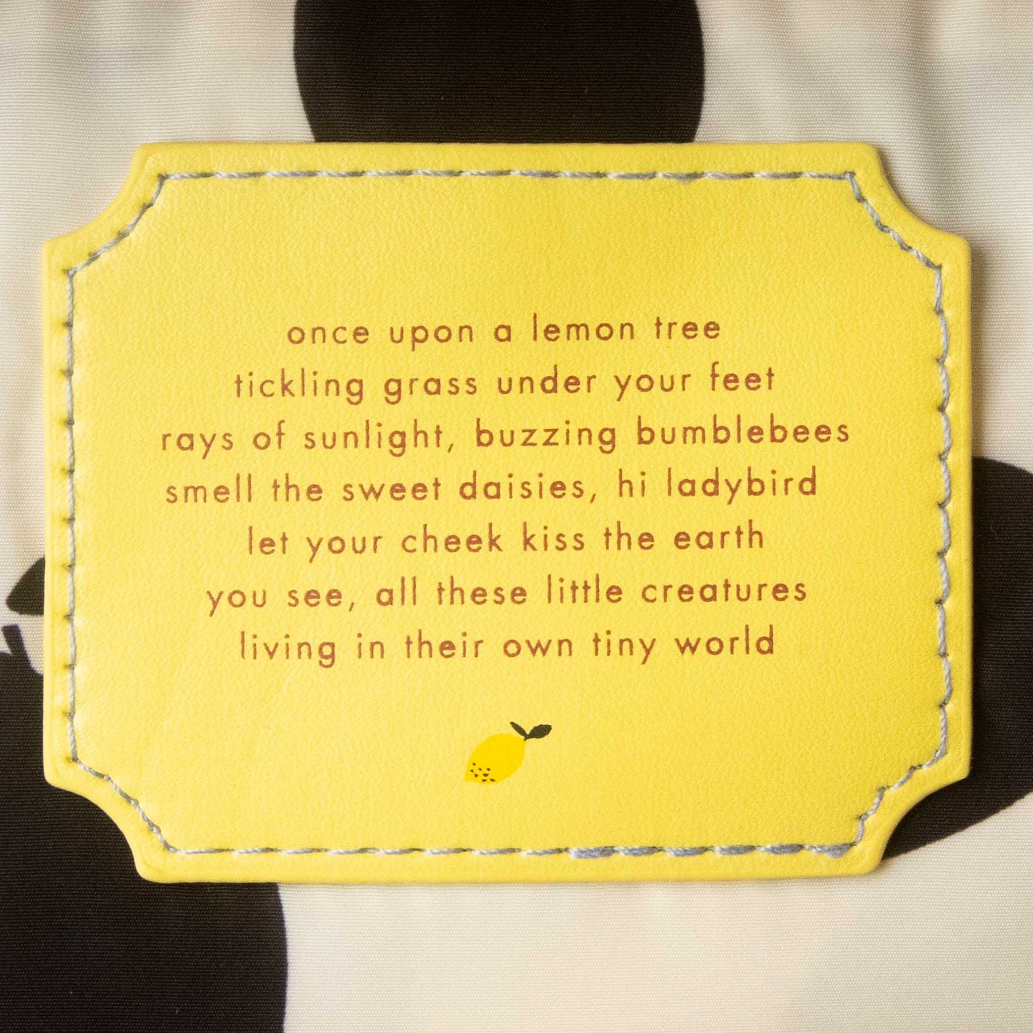 recycled-lemon-tree-envelope-backpack-medium-campfire-orange Yellow card with a poem and lemon illustration on a black background