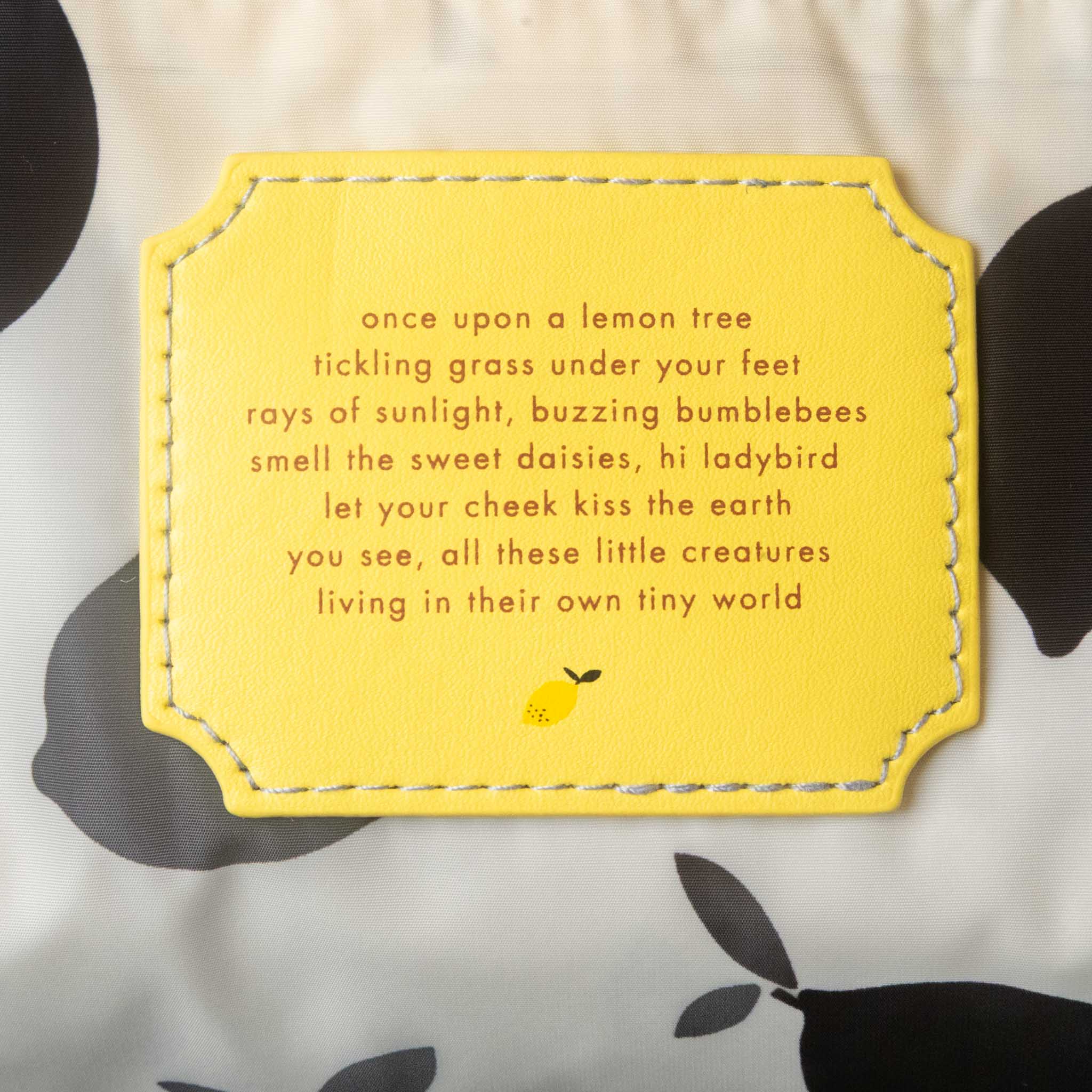 Yellow label with text and a lemon illustration on a patterned background
