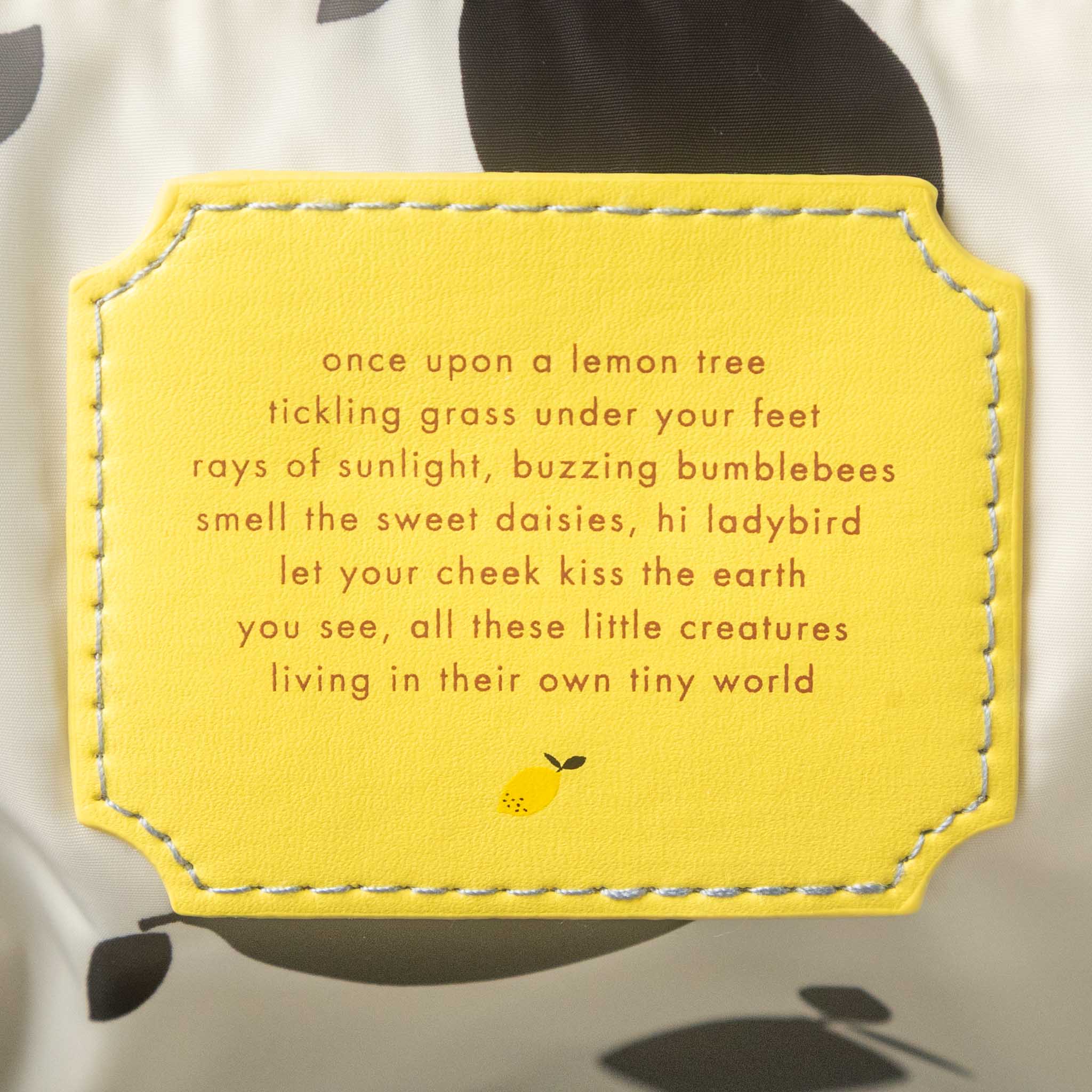 Yellow patch with text and a lemon illustration on a fabric background
