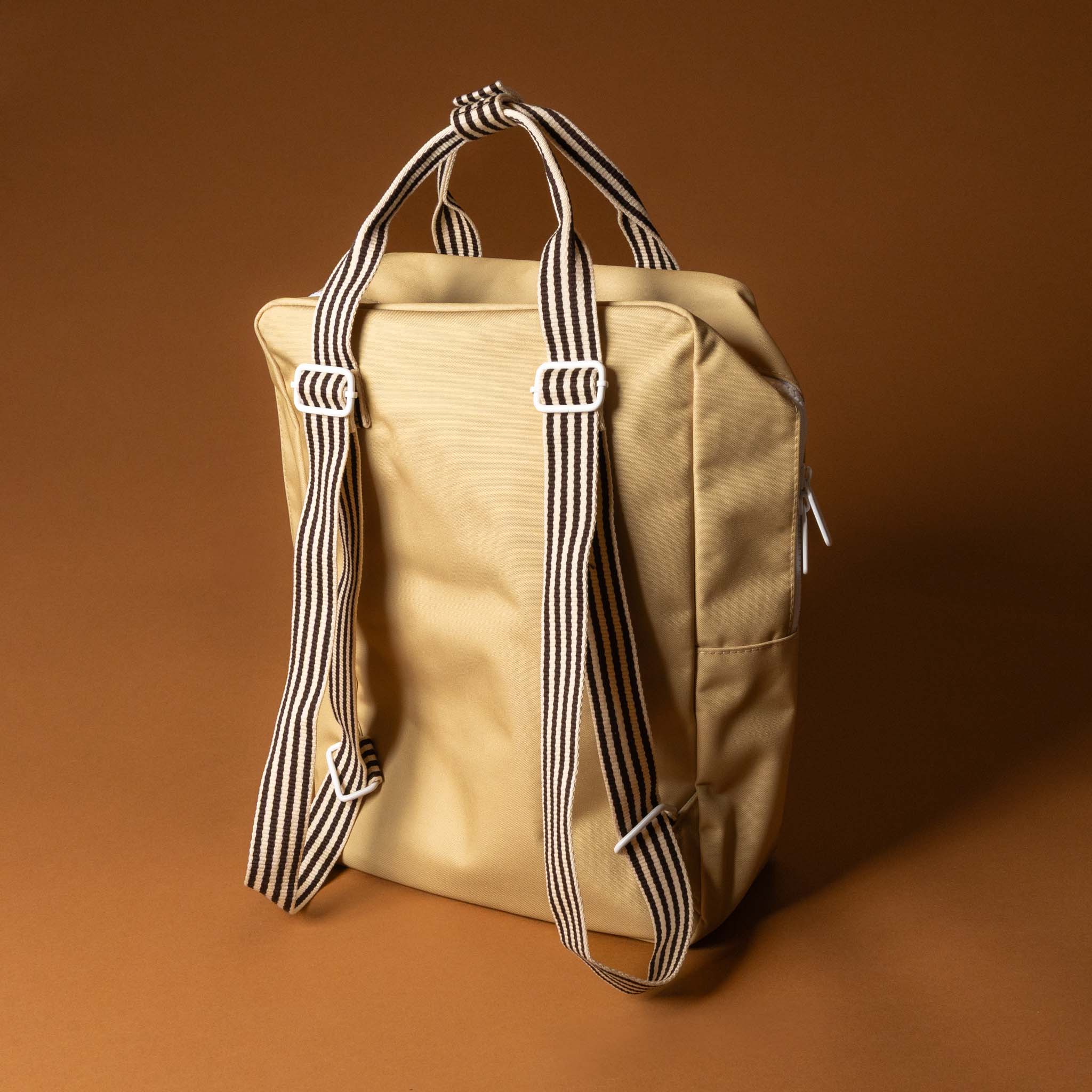 recycled-wonders-envelope-backpack-large-sandy-beach-with-a-red-pocket-black-striped-straps-back
