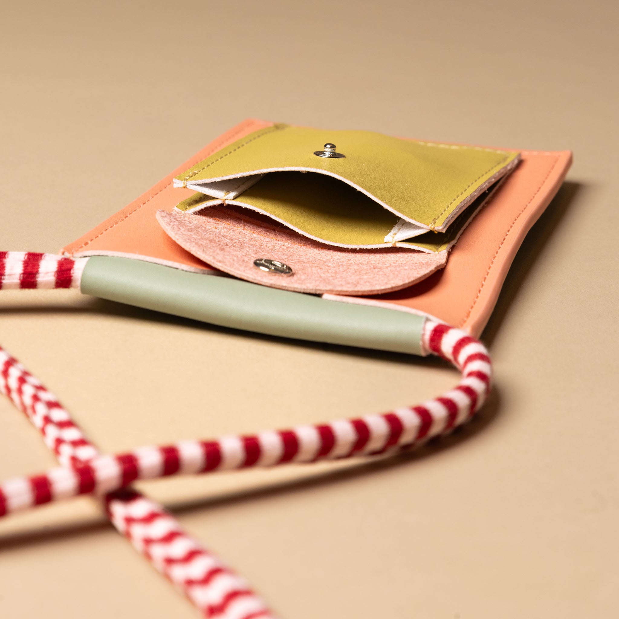 recycled-wonders-phone-pouch-coral-pink-with-red-and-white-striped-strap-open-front-pocket