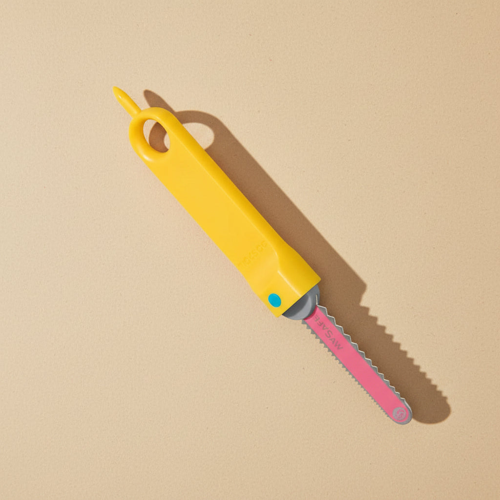 Yellow and pink folding knife on a white background