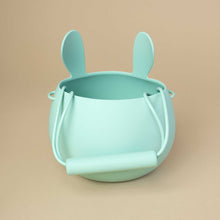 Load image into Gallery viewer, pistachio colored silicone bucket in bunny shape, view from  of the handle from the back
