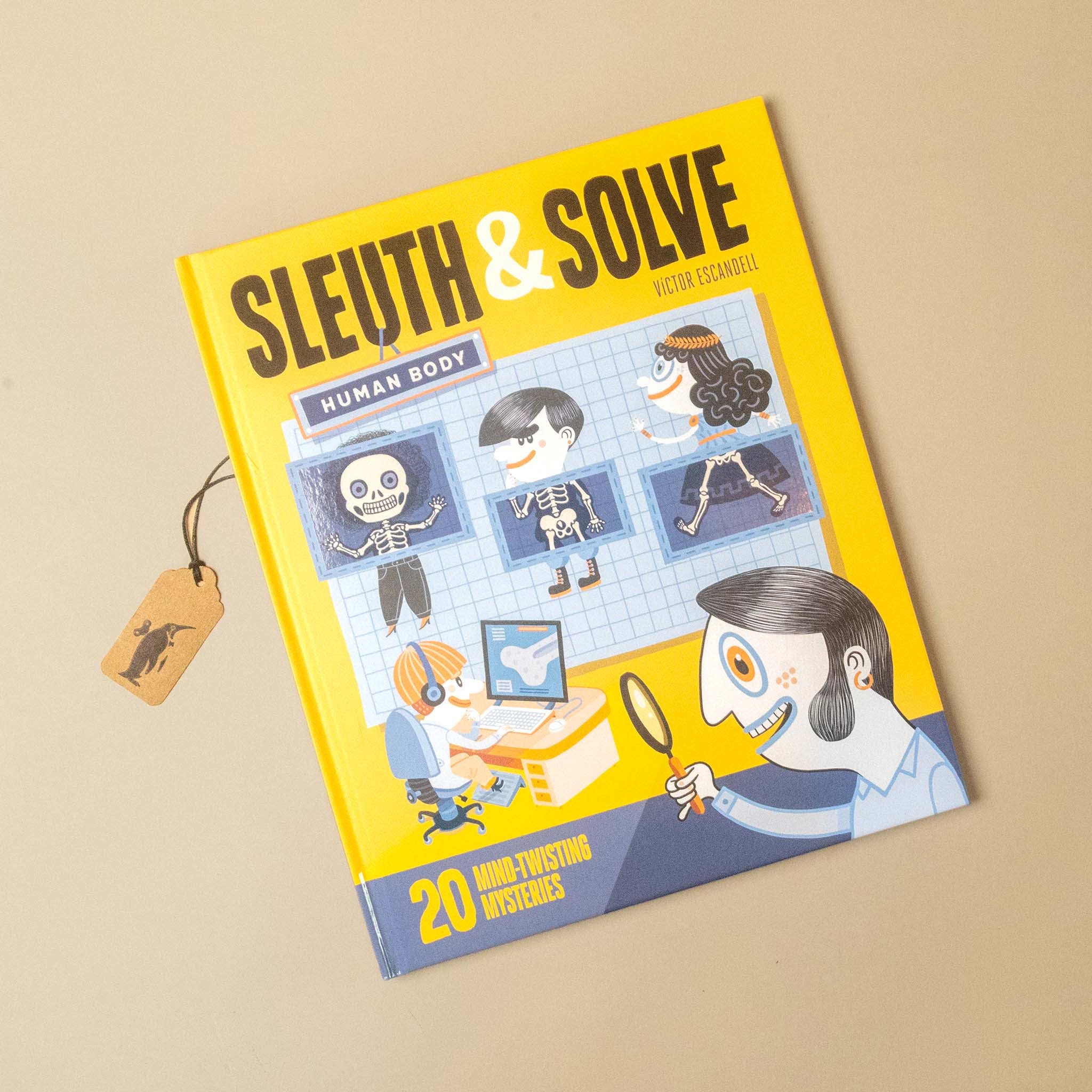 A yellow children's book titled 'SLEUTH & SOLVE: Human Body' by Fifth Chamber, shown at an angle on a beige background with a small paper tag attached.