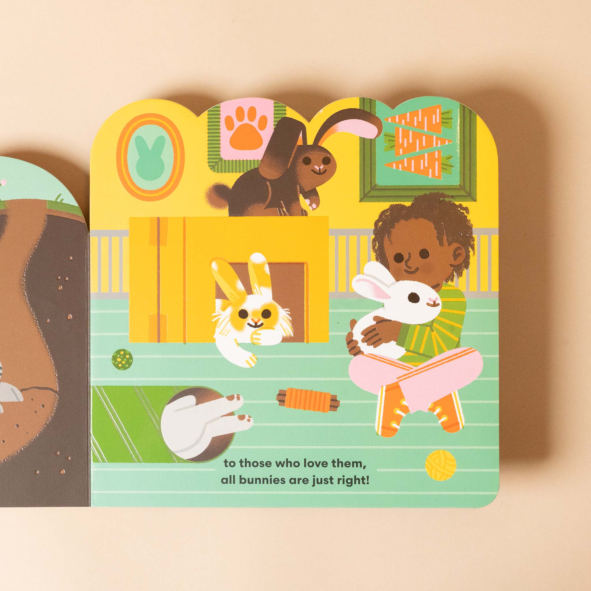 some-bunnies-board-book children's book with illustrations of a child holding a bunny and various bunny characters on a beige background.