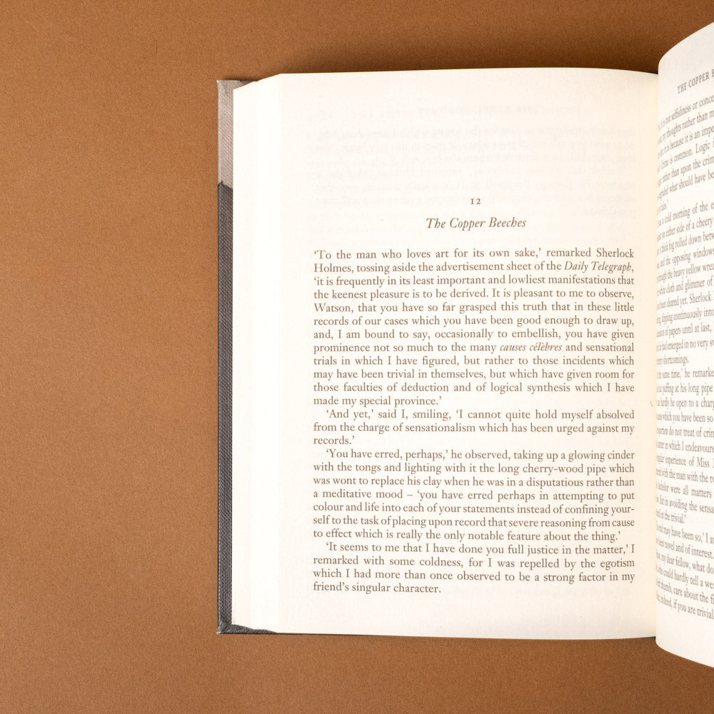 the-adventures-of-sherlock-holmes Open book on a brown background