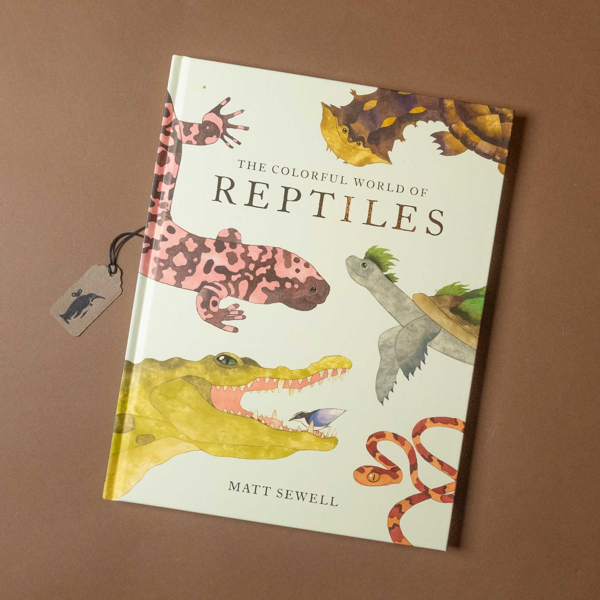 Book titled 'The Colorful World of Reptiles' by Matt Sewell on a brown background