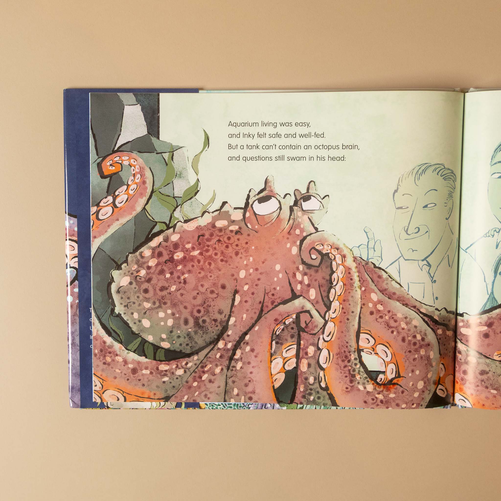 An open children's book showing a colorful illustration of an octopus with tentacles and text on the left page, photographed against a warm beige background.
