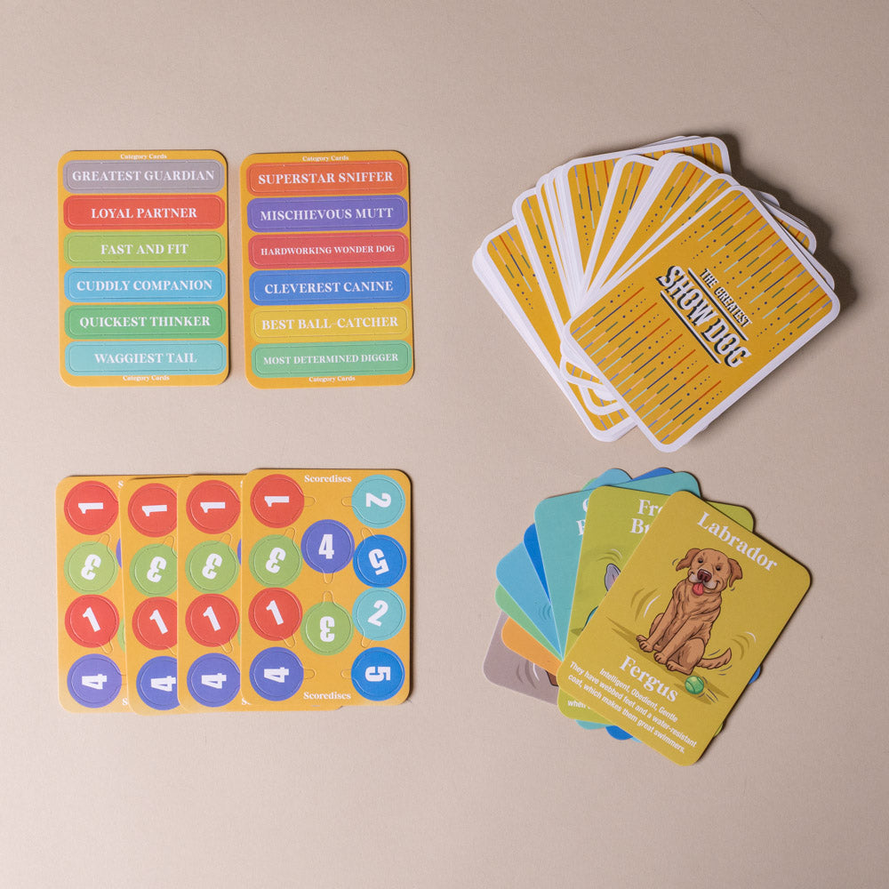 the-greatest-show-dog-family-card-game Collection of colorful cards with various designs on a beige background