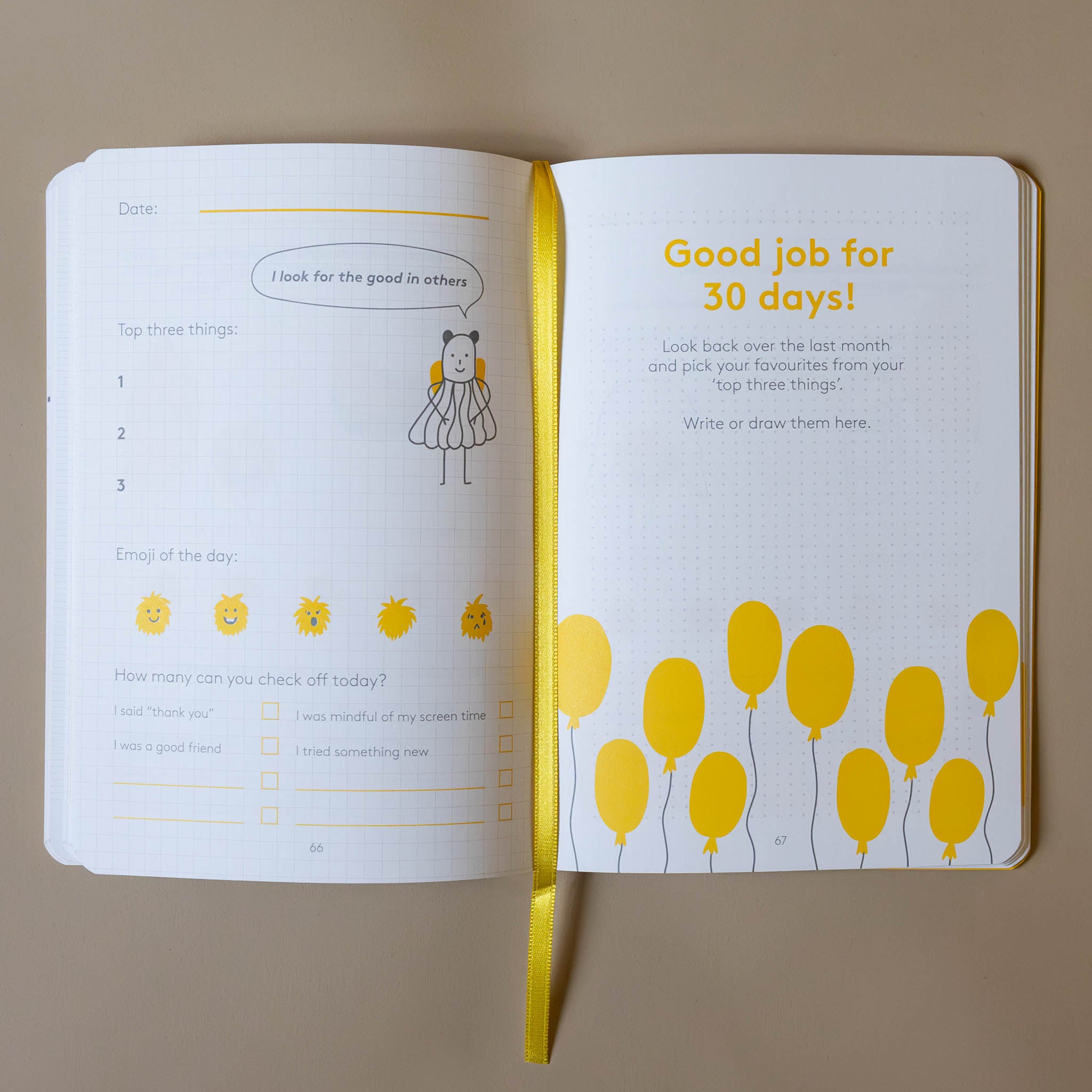 Open yellow-the-happyme-journal-junior with yellow balloons and motivational text on a beige background