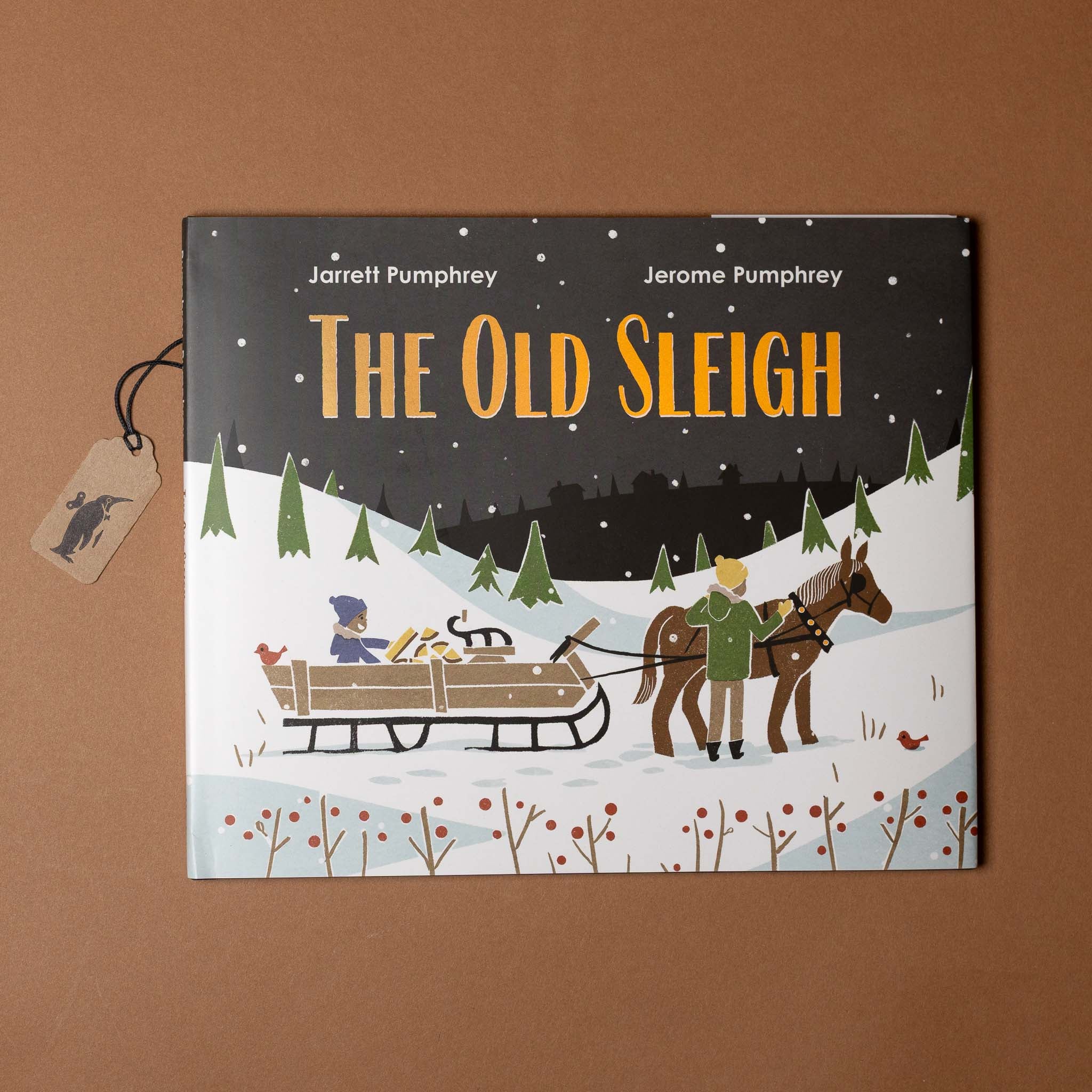 Book cover of 'The Old Sleigh' with winter scene illustration on a brown background