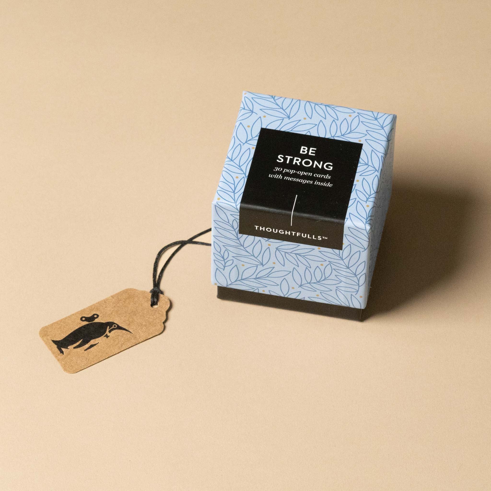 thoughtfulls-pop-open-cards-be-strong Box with 'Be Strong' message and Thoughtfuls branding on a beige background