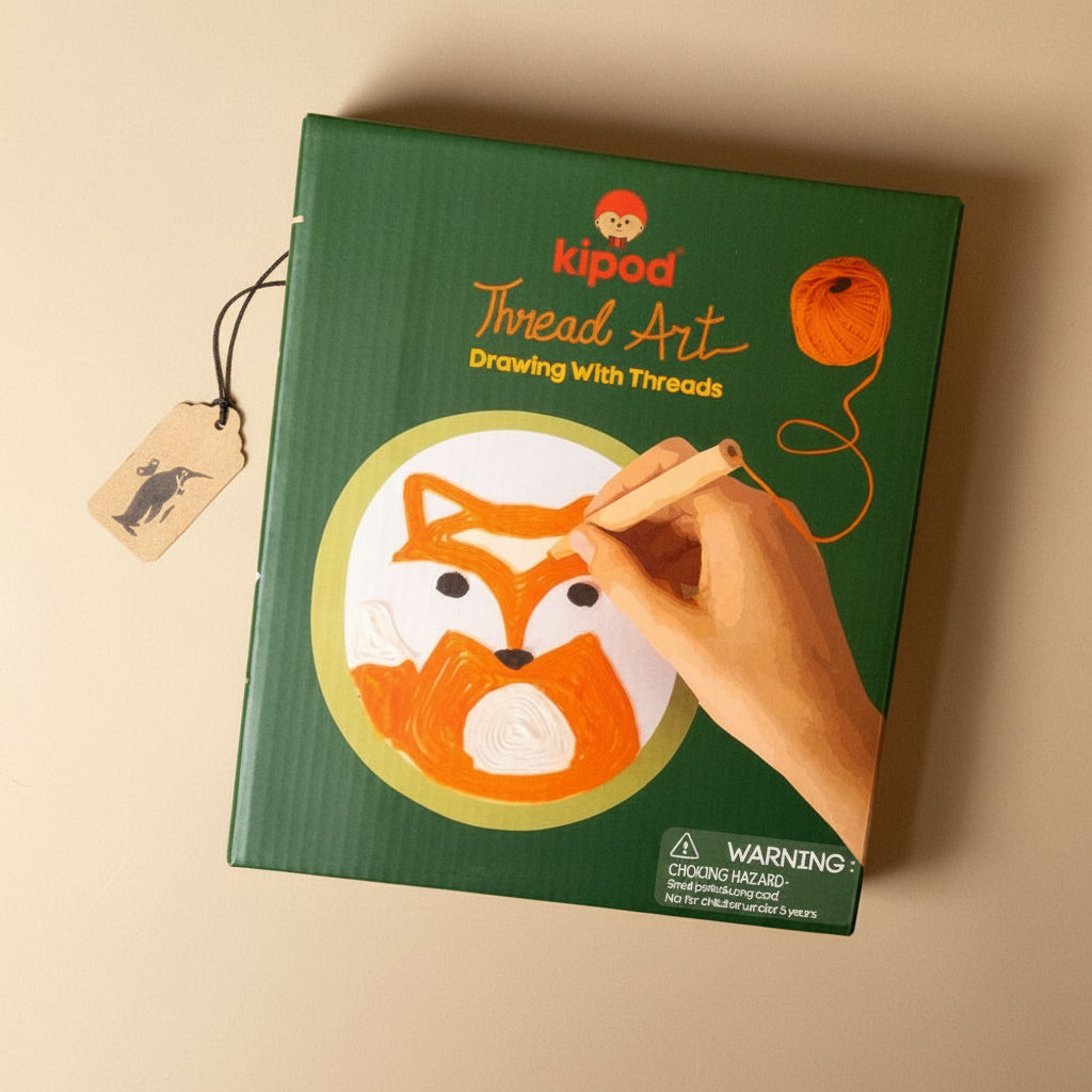 green-box-Thread Art kit with a hand holding a thread, on a beige background