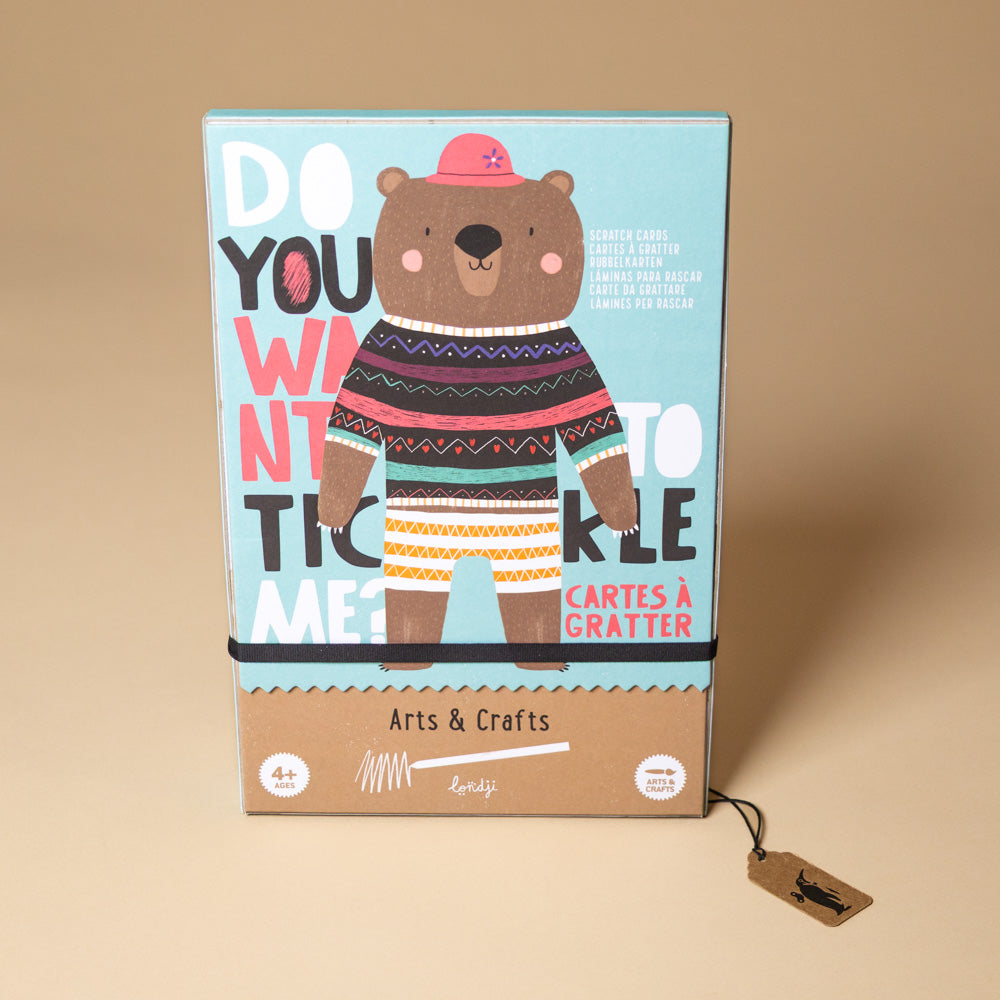 tickle-me-arts-and-crafts-kit Cartoon bear in a sweater on a colorful box with text against a beige background