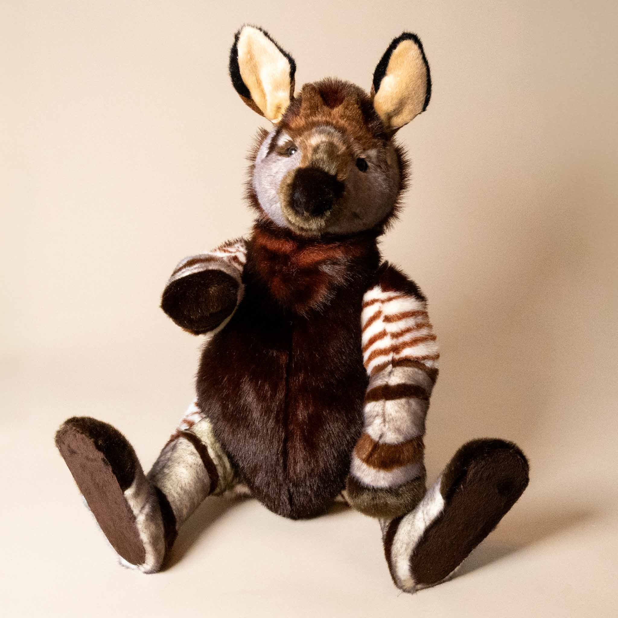 trailblazer-the-traveling-okapi-standing-stuffed-animal-sitting