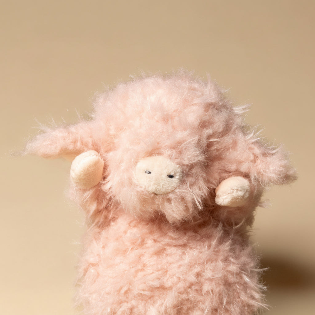 wee-piggy-hammie Pink plush sheep toy on a beige background