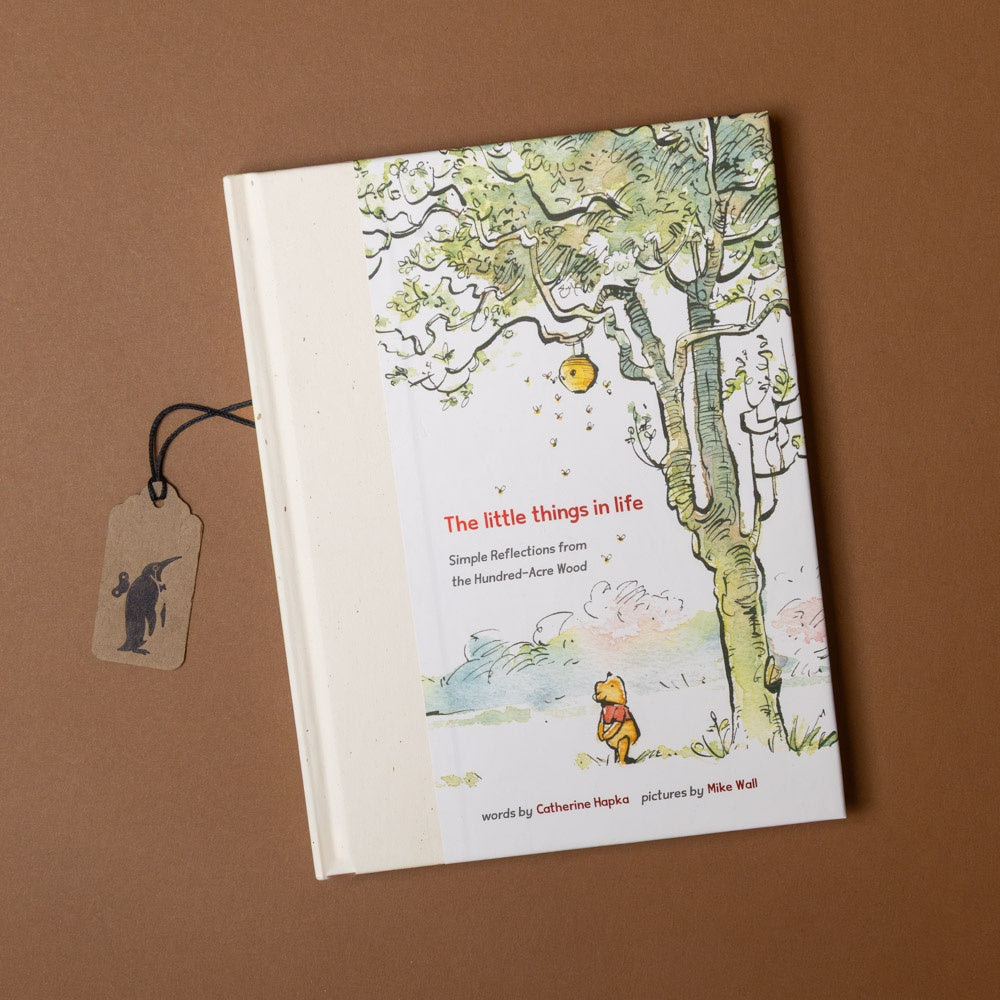 Book titled 'The Little Things in Life' with a tree illustration on a brown background