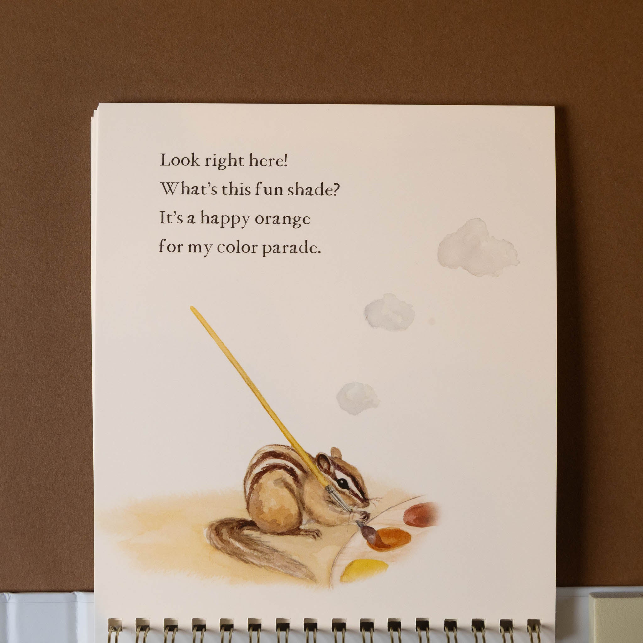wishy-washy-water-reveal-a-board-book-of-first-words--colors with a chipmunk illustration and text on a brown background