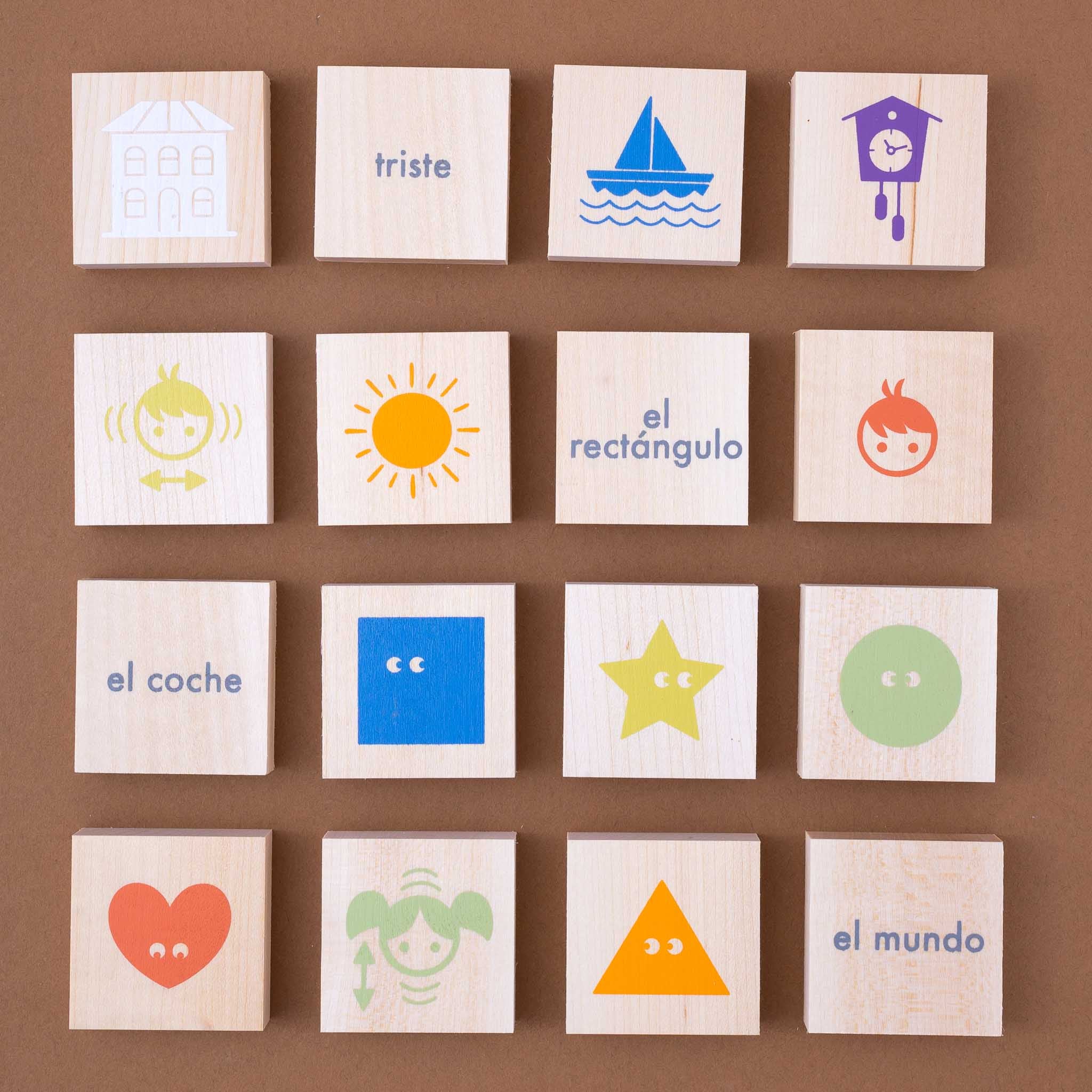 wooden-chip-set-spanish-vocabulary Set of wooden blocks with colorful illustrations and Spanish text on a brown background