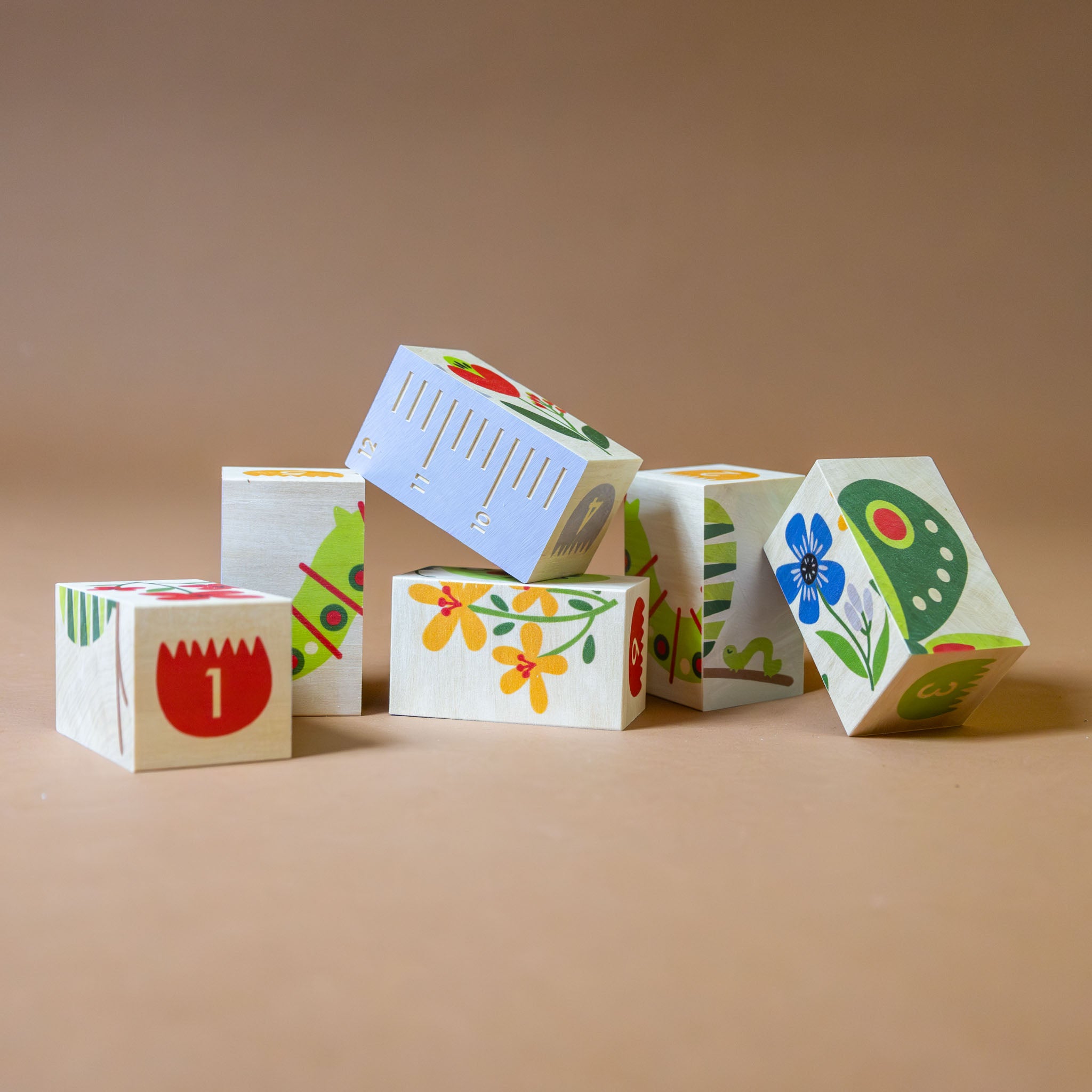 wooden-environment-bock-set-garden-with-two-green-catepillars-flowers-numbers-on-tulips