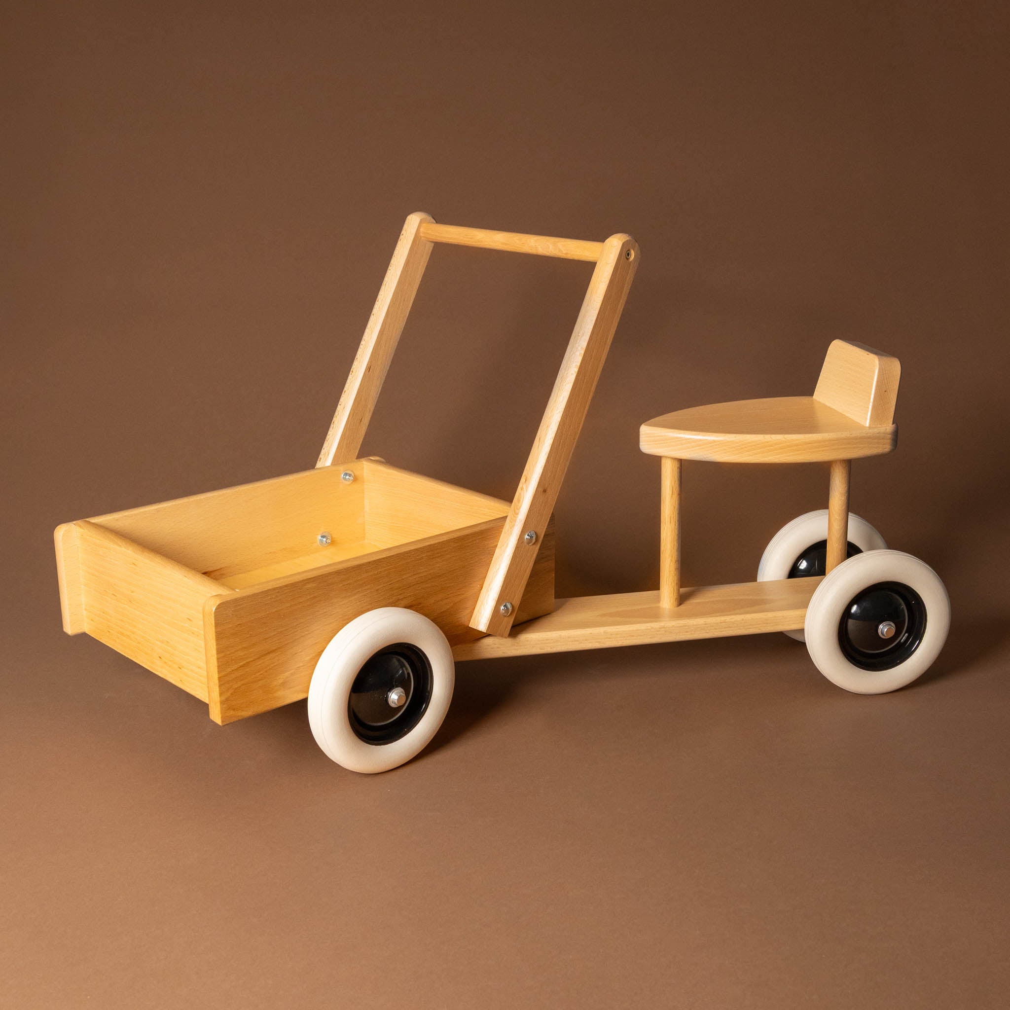 wooden-sit-and-ride-with-cargo-box Wooden toy with a seat and pull handle on a brown background